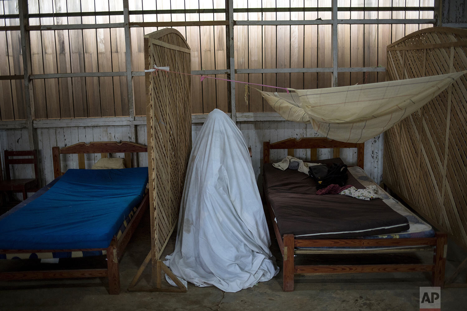  Sara Magin, who suffers COVID-19 symptoms, sits under a bedsheet for herbal vapor therapy in the Shipibo Indigenous community of Pucallpa, in Peru's Ucayali region, Sept. 1, 2020. The treatment center takes the holistic approach to treating the viru
