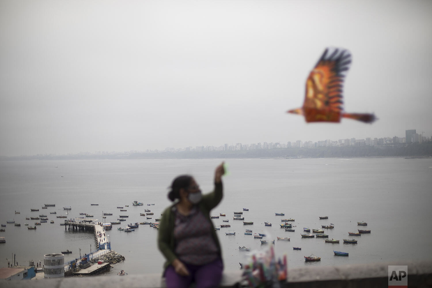  A woman sells kites on the seaside walk in the Chorrillos area of Lima, Peru, Sept. 19 2020. (AP Photo/Rodrigo Abd) 