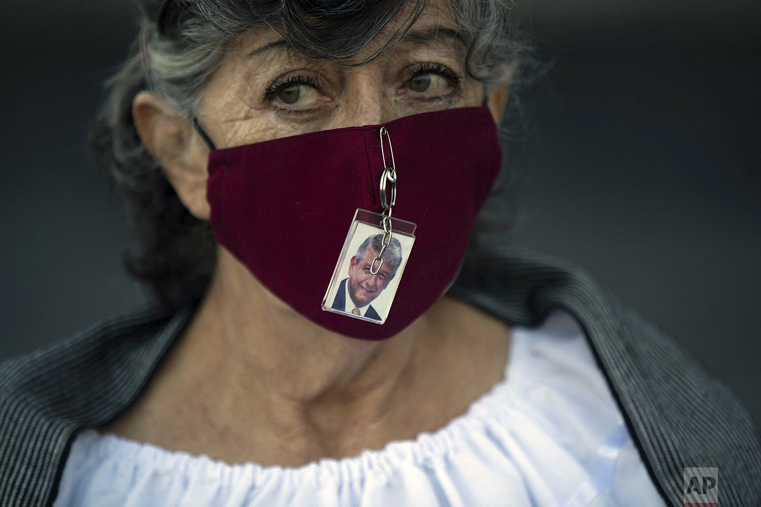  A supporter of Mexican President Andres Manuel Lopez Obrador wears a photo of him pinned to her mask outside the presidential palace where he gives his second state-of-the-union address in Mexico City, Sept. 1, 2020. Obrador emphasized what he consi