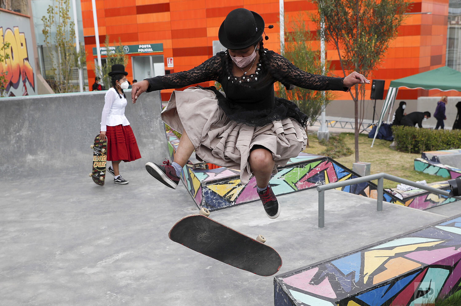  Aide Choque jumps her skateboard during a youth talent show in La Paz, Bolivia, Sept. 30, 2020. The girls of the collective “ImillaSkate,” a mixture of Aymara and English meaning girl and skateboarding, wear the Indigenous dress of their grandmother