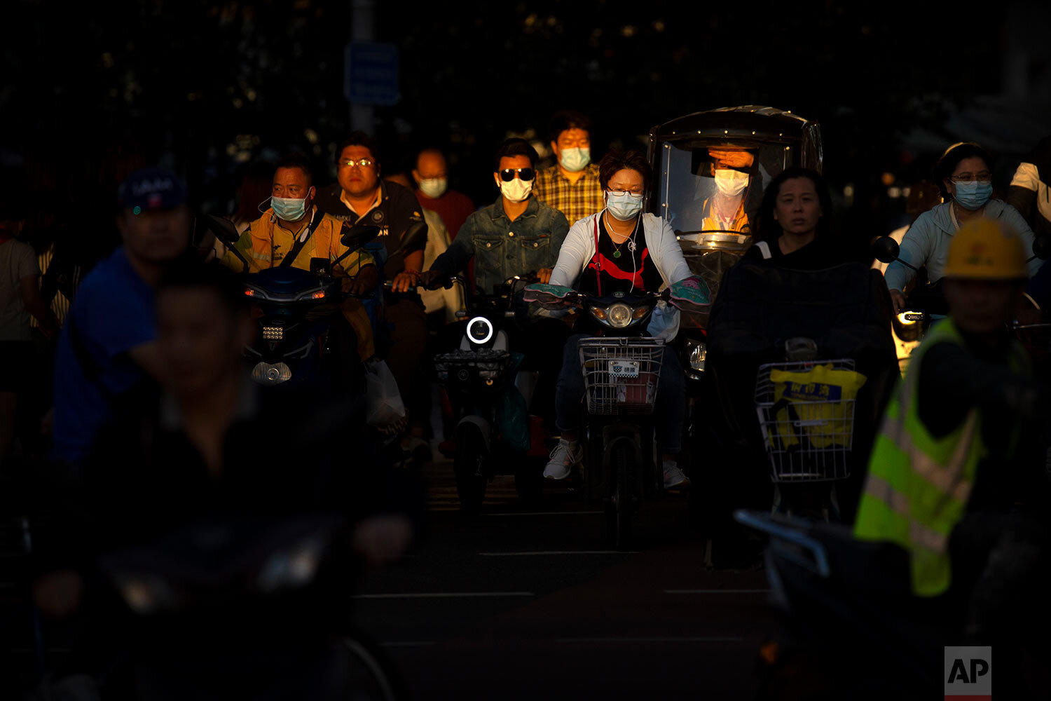  People wearing face masks to protect against the coronavirus cross an intersection in Beijing, Wednesday, Sept. 16, 2020. (AP Photo/Mark Schiefelbein) 
