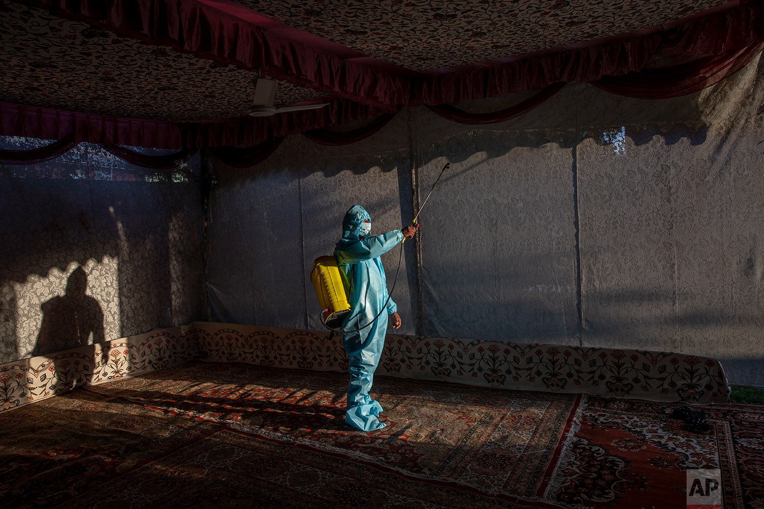  A Kashmir man in personal protective equipment sprays disinfectant to sanitize a wedding tent on the outskirts of Srinagar, Indian controlled Kashmir, Thursday, Sept. 17, 2020.  (AP Photo/ Dar Yasin) 