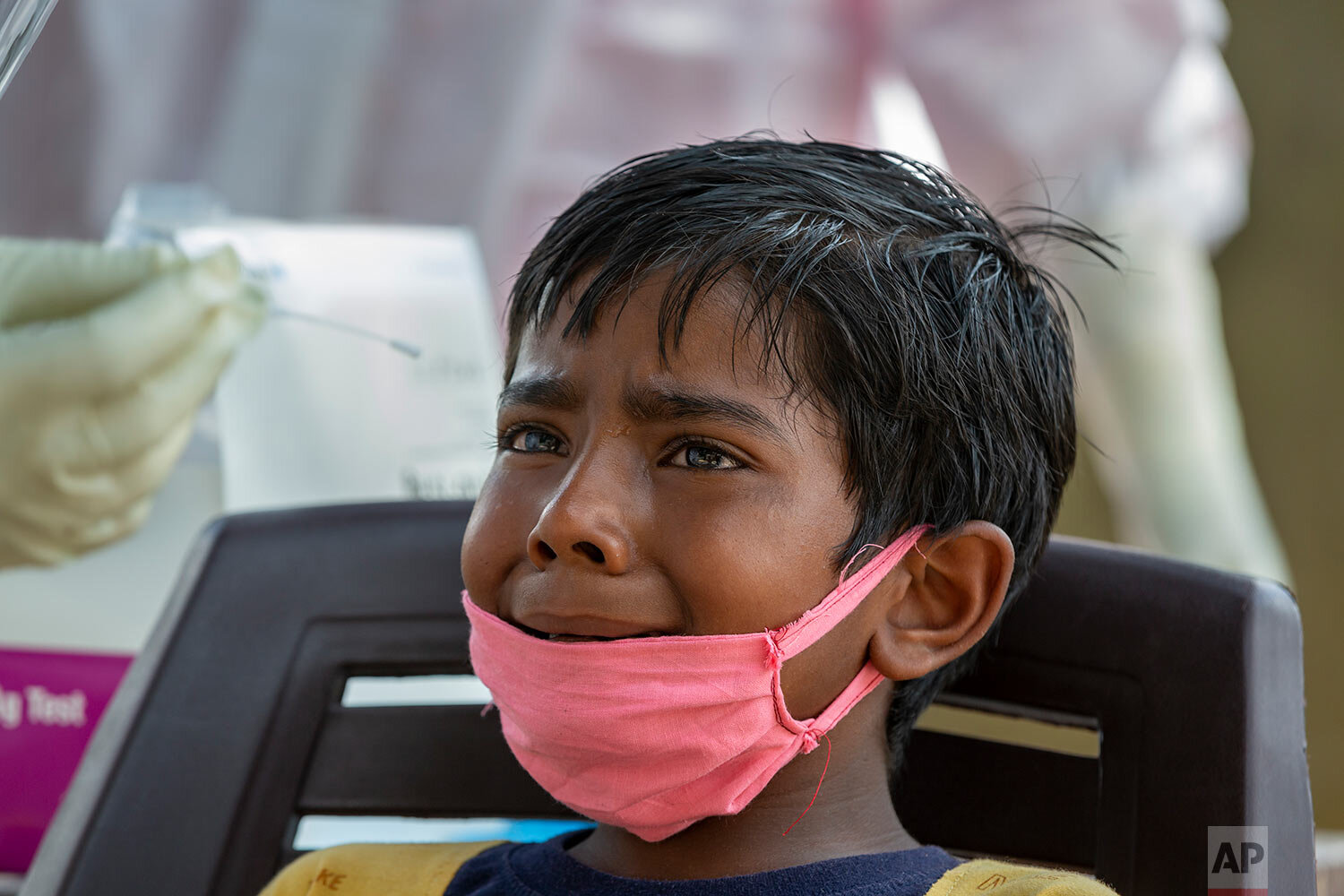  An Indian boy cries as a medical worker prepares to collect his swab sample for COVID-19 test at a rural health centre in Bagli, outskirts of Dharmsala, India, Monday, Sept. 7, 2020. (AP Photo/Ashwini Bhatia) 
