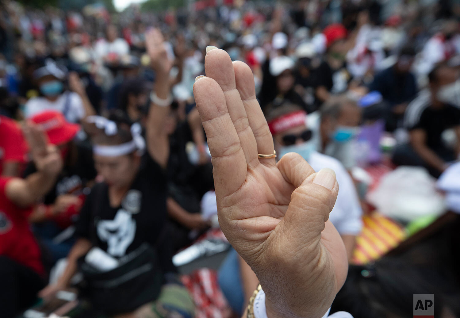  Pro-democracy demonstrators raise a three-finger salute, a symbol of resistance, during a protest outside the Parliament in Bangkok, Thailand, Thursday, Sept. 24, 2020. (AP Photo/Sakchai Lalit) 