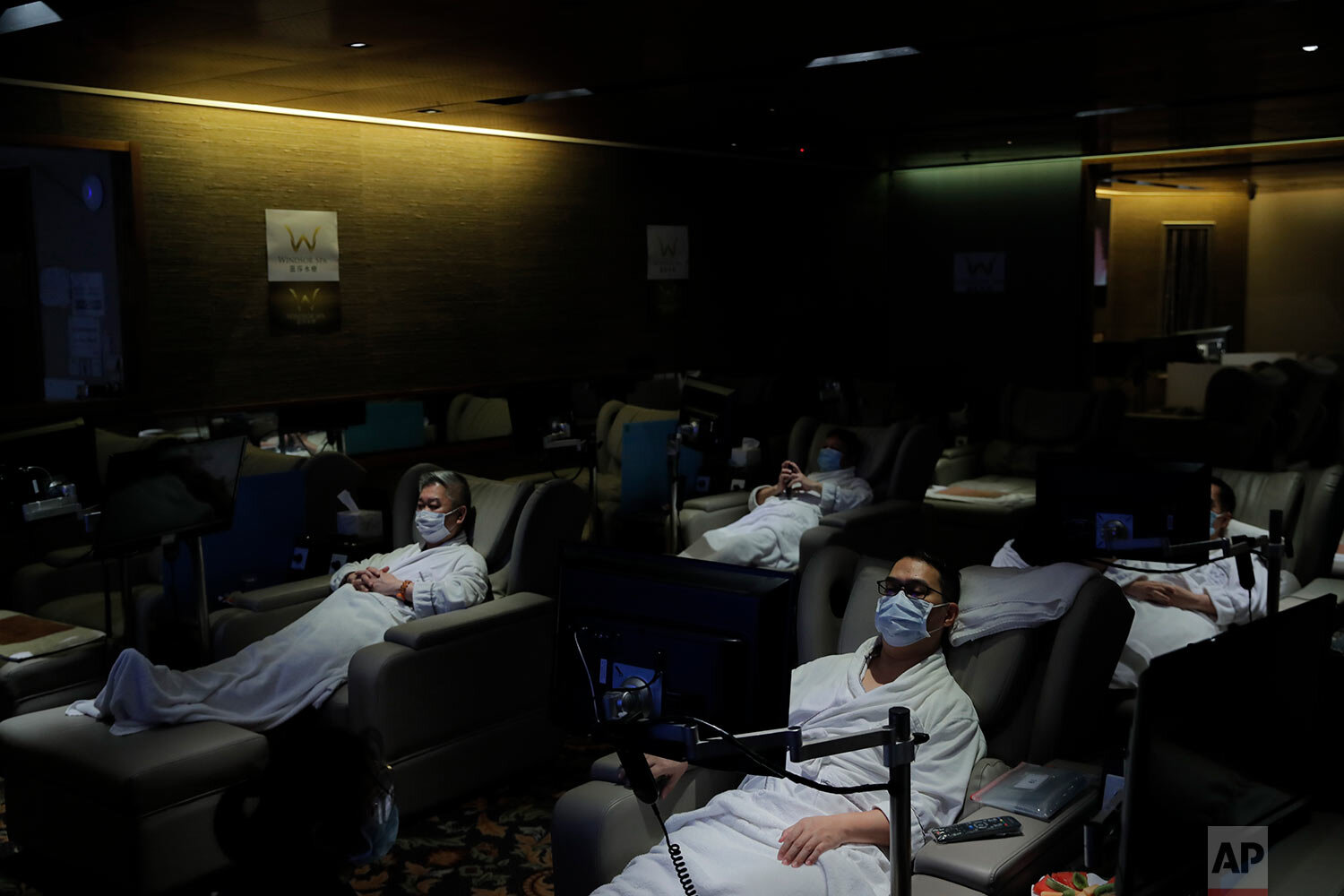  Staff members wearing face masks demonstrate the safety measures to media as the massage spa plans to reopened in Hong Kong, Thursday, Sept. 17, 2020.  (AP Photo/Kin Cheung) 