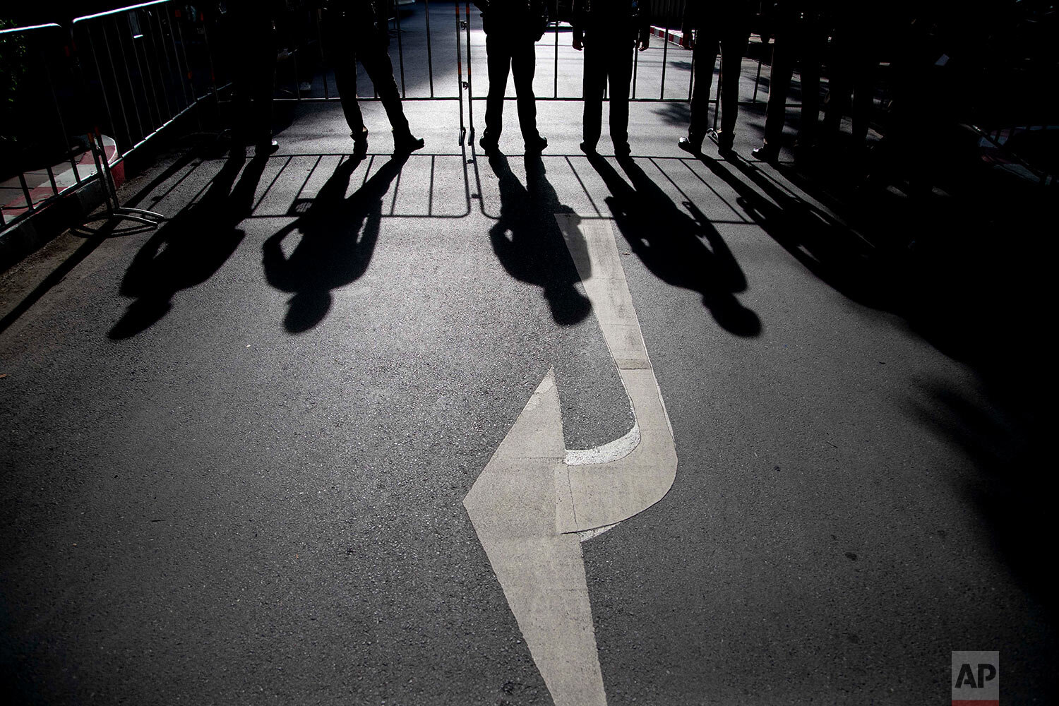  Shadows of standing police officers are cast on the ground at the entrance to the criminal courthouse in Bangkok, Thailand, Thursday, Sept. 3, 2020. (AP Photo/Gemunu Amarasinghe) 