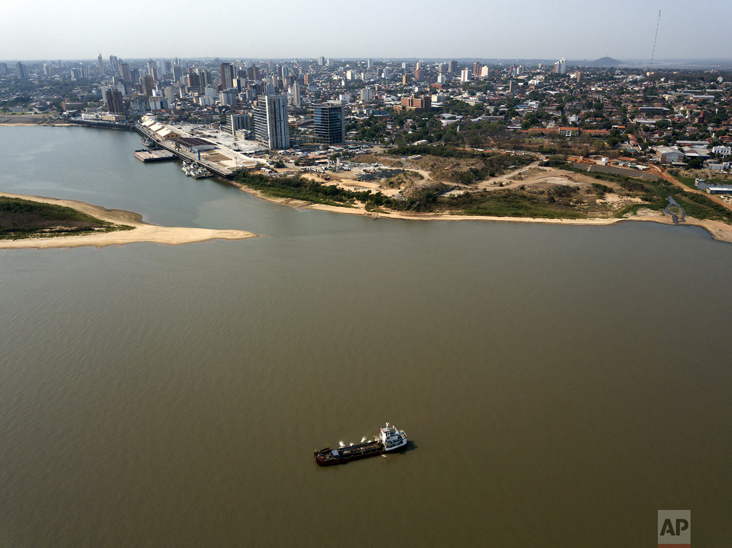  A ship extracts sand from the river bed of Paraguay River, taking advantage of its low water level, off the shores of Asuncion, Paraguay, Thursday, Oct. 8, 2020. (AP Photo/Jorge Saenz) 