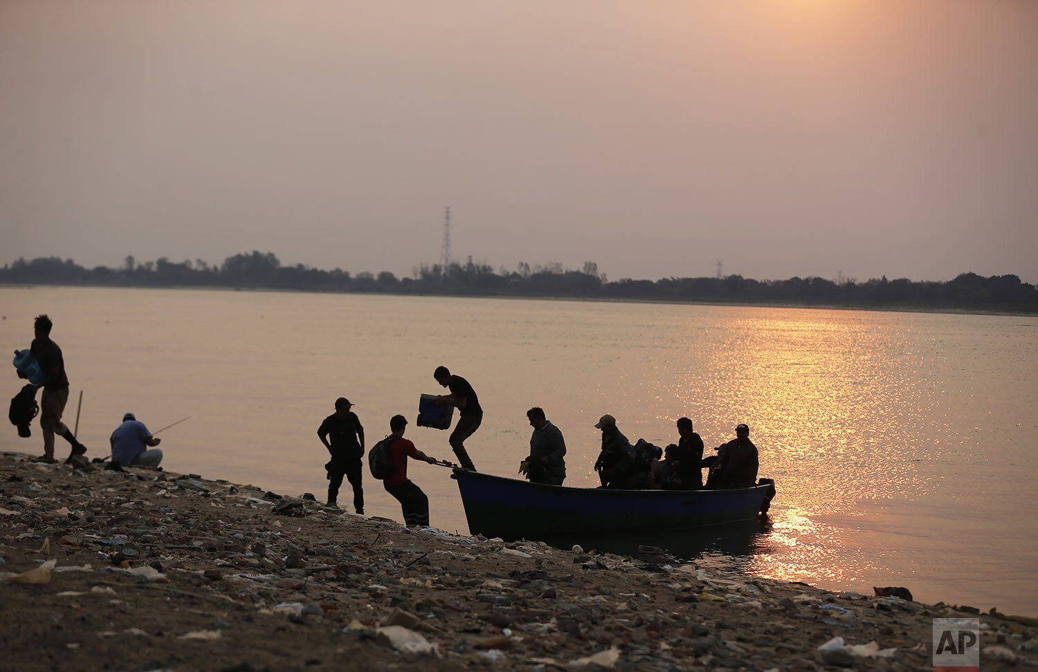  Shipyard workers return to Asuncion, Paraguay after working on the other side of the Paraguay River, Wednesday, Oct. 7, 2020. (AP Photo/Jorge Saenz) 