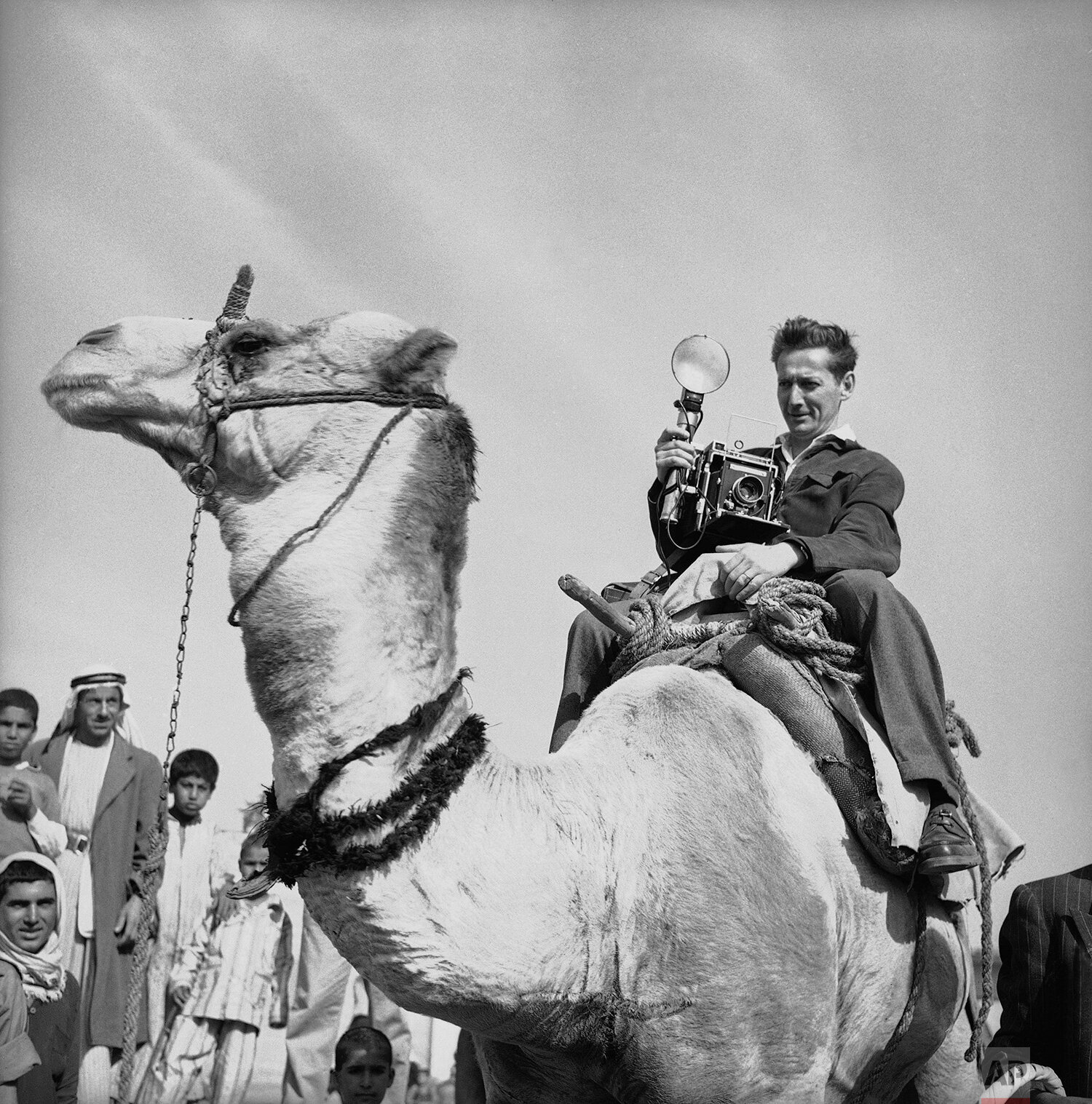  Paris staff photographer Jean-Jacques Levy riding a camel whilst on assignment on Dec. 3, 1956, in Khan Yunis in the Gaza strip. (AP Photo) 