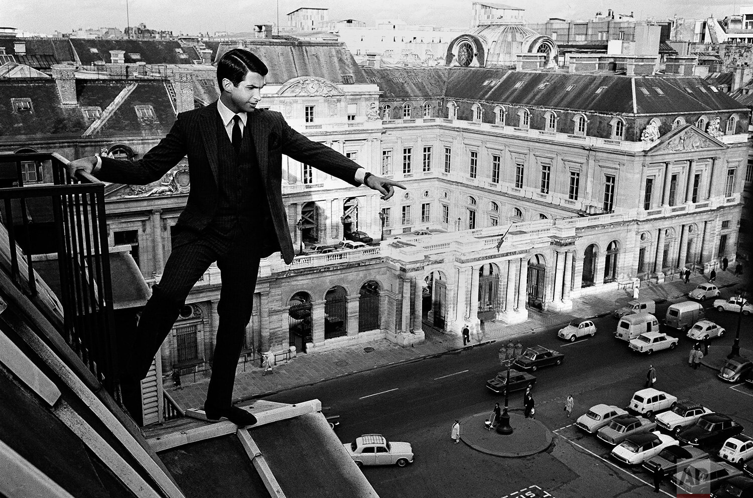  Actor George Hamilton walks on the roof of Hotel Louvre as he was filming ‘Jack of Diamonds’ on Oct. 17, 1966, in Paris, France. In the background is the building of the Le Conseil d’Etat (State Council). (AP Photo/Jean-Jacques Levy) 