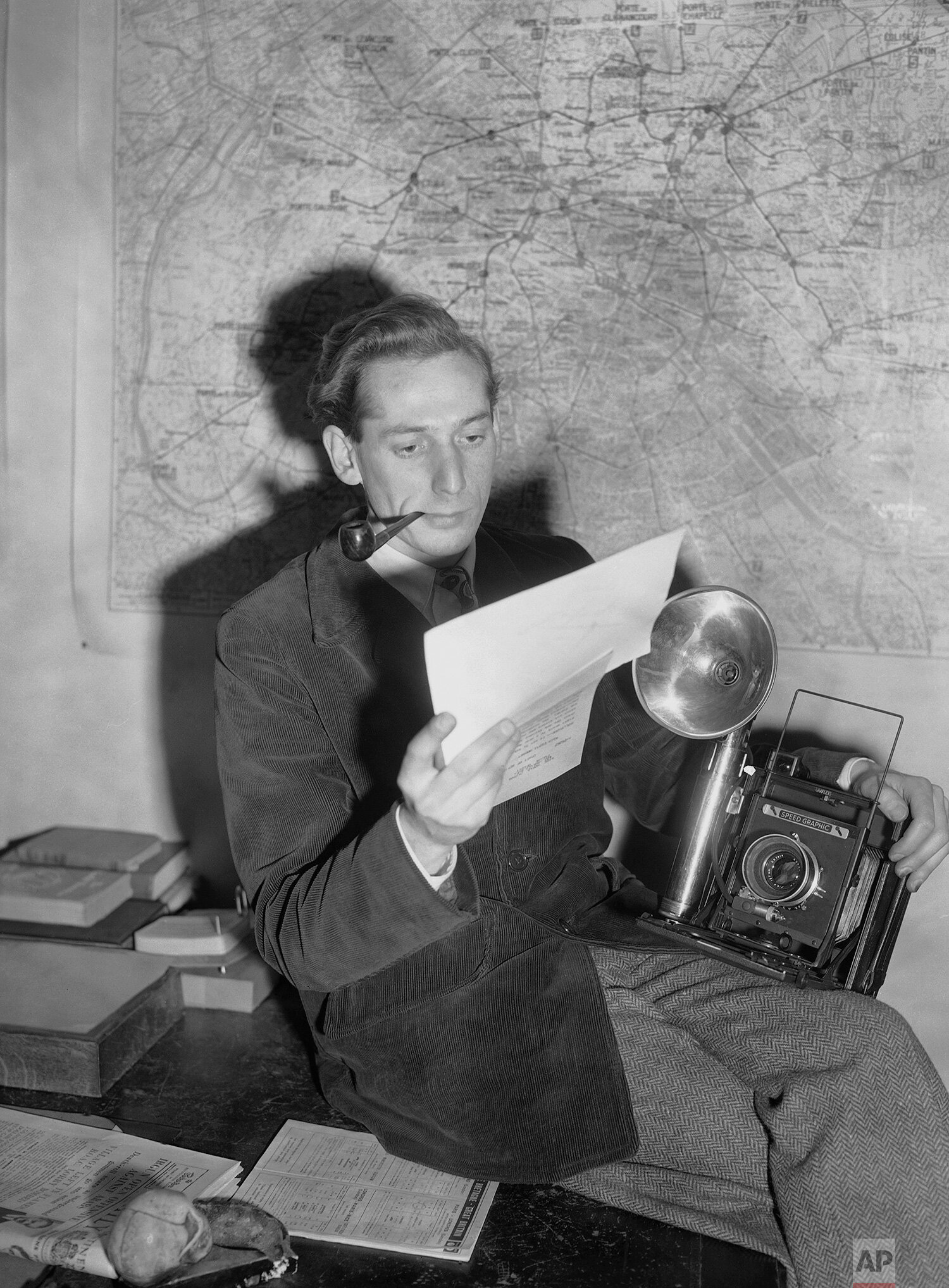  Jean-Jacques Levy, staff photographer reading in the Paris bureau of the Associated Press, on Dec. 14, 1947. (AP Photo) 