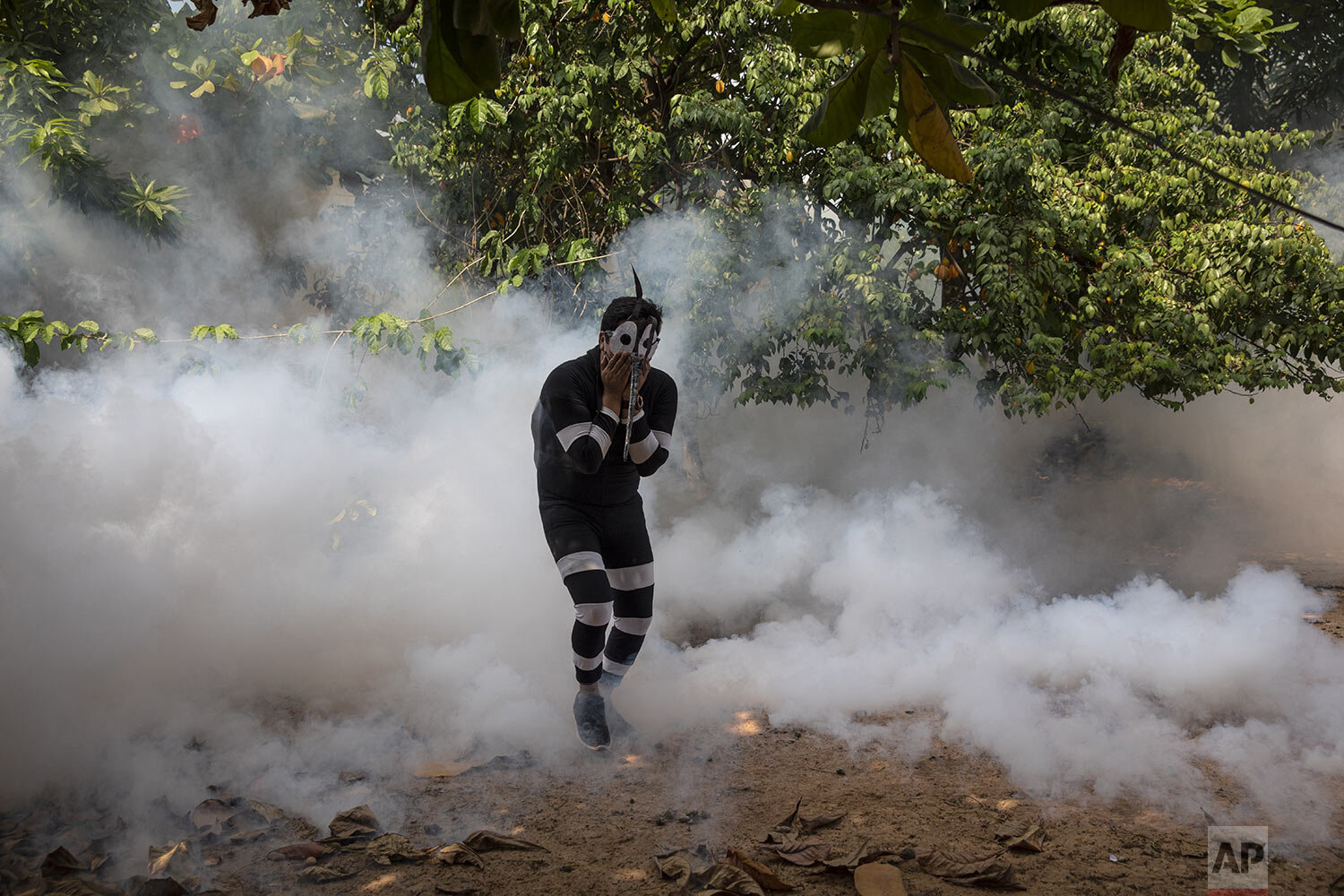  An actor who was hired by the government to assume the role of a mosquito is engulfed by clouds of pesticide during a fumigation campaign against dengue in Pucallpa, in Peru’s Ucayali region, Saturday, Oct. 3, 2020. (AP Photo/Rodrigo Abd) 