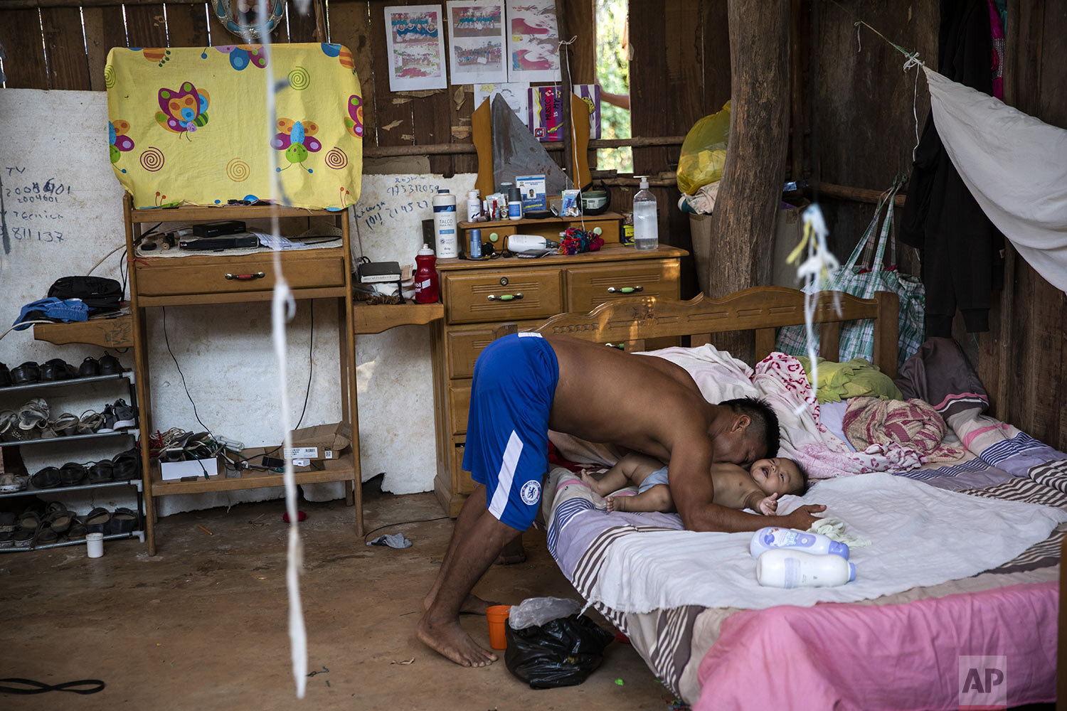  Rolando Cegarra nuzzles his 4-month-old grandson, inside his home in the Caimito Native Community, in Peru’s Ucayali region, Monday, Oct. 4, 2020. (AP Photo/Rodrigo Abd) 