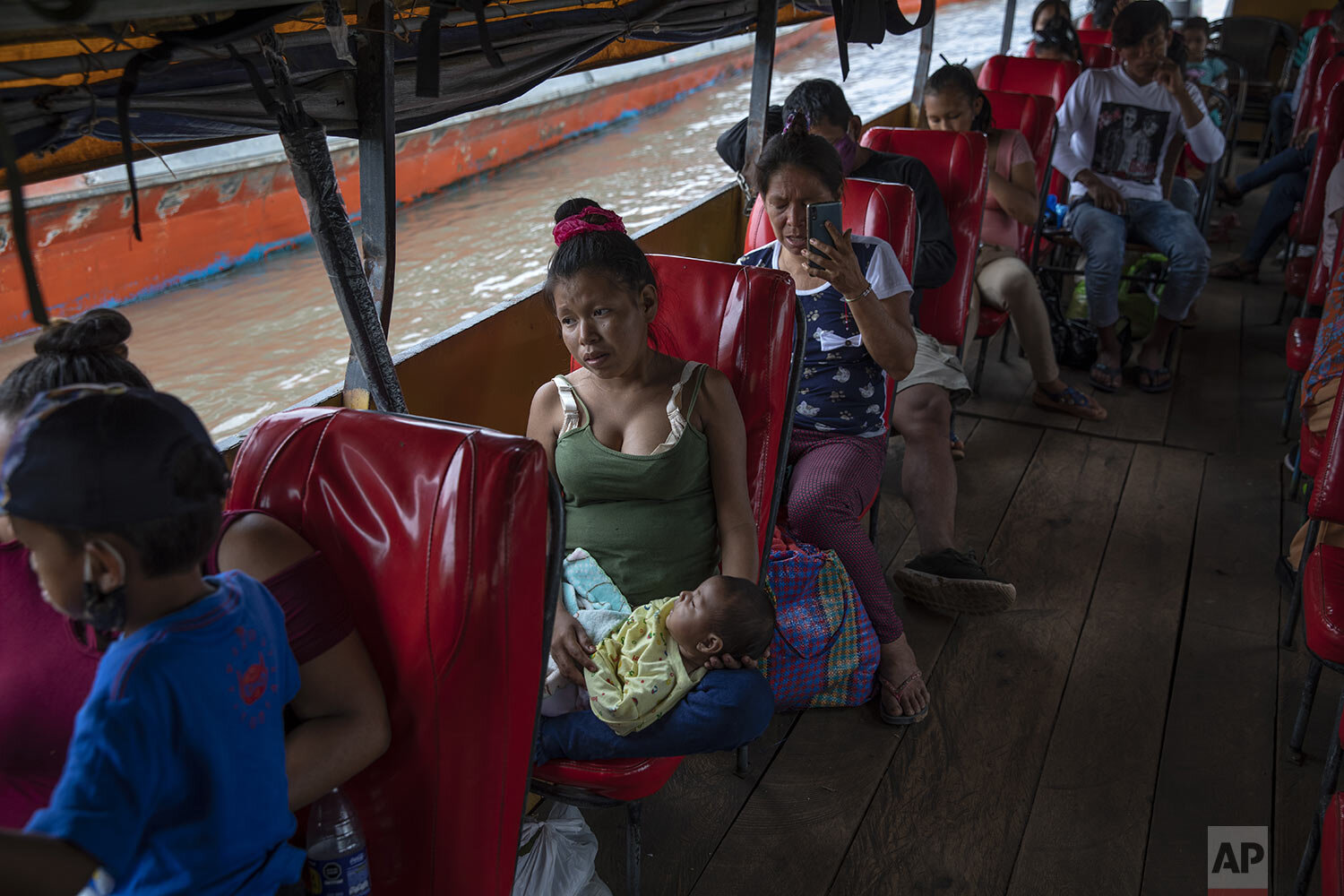  Amazonian residents wait for a public boat to leave the Pucallpa port, in Peru’s Ucayali region, Monday, Oct. 4, 2020. (AP Photo/Rodrigo Abd) 