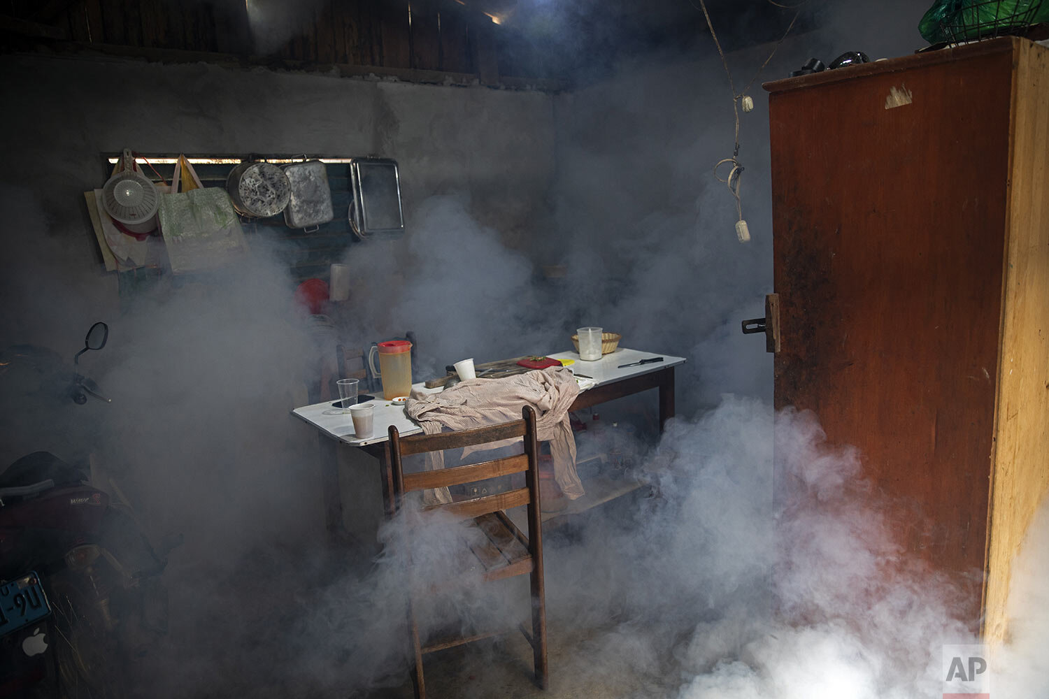  Clouds of insecticide seep into a dining room during a fumigation operation to help control the spread of dengue fever, in downtown Pucallpa, Peru, Tuesday, Sept. 29, 2020. (AP Photo/Rodrigo Abd) 