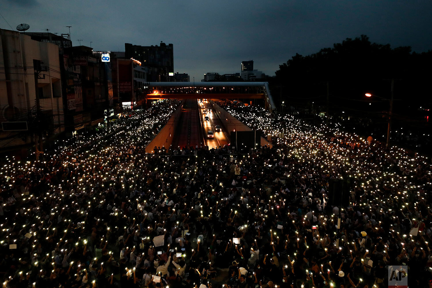  Pro-democracy activists wave mobile phones with lights during a demonstration at Kaset intersection, suburbs of Bangkok, Thailand, Monday, Oct. 19, 2020. (AP Photo/Sakchai Lalit) 