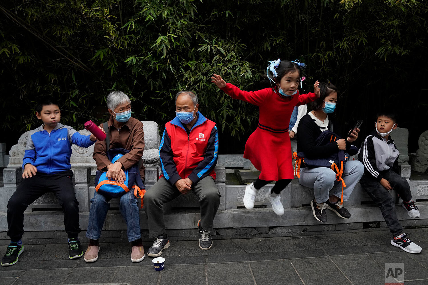  Tourists wearing masks to protect themselves from the coronavirus visit the popular Nanluogu alley area on the last day of the National Day holidays in Beijing on Thursday, Oct. 8, 2020. (AP Photo/Ng Han Guan) 