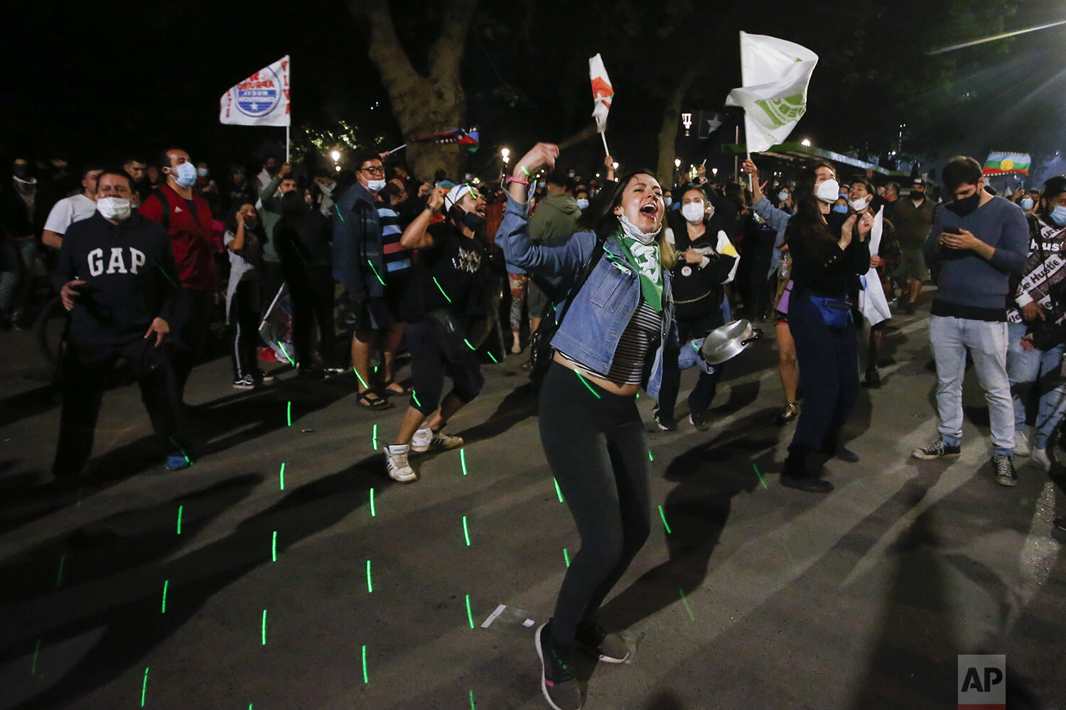  People celebrate after a referendum vote outcome favored replacing Chile’s 40-year-old constitution, written during the dictatorship of Gen. Augusto Pinochet, at Plaza Italia in Santiago, Chile, early Oct. 26, 2020. (AP Photo/Luis Hidalgo) 