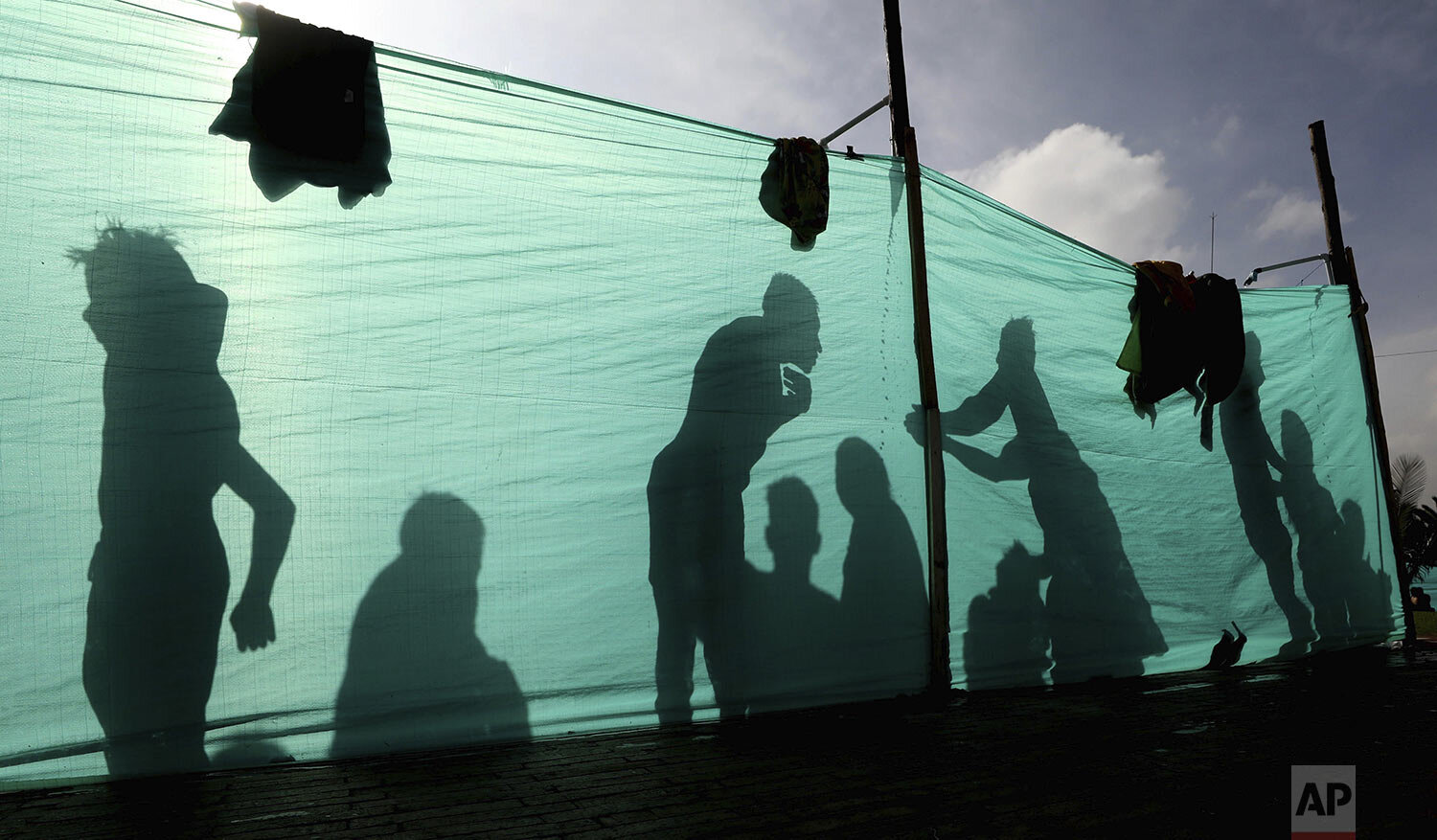  Indigenous protesters wash up before marching in Bogota, where they traveled in a caravan from the interior of Colombia, Oct. 19, 2020. (AP Photo/Fernando Vergara) 