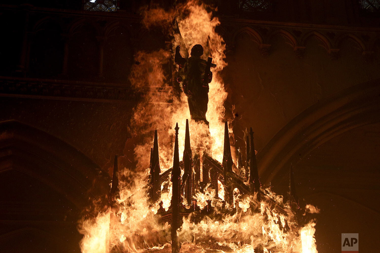  A saint statue is engulfed in flames after protesters torched the San Francisco de Borja church, a favorite of Chile's national police force, on the one-year anniversary of the start of mass, anti-government protests over inequality in Santiago, Chi