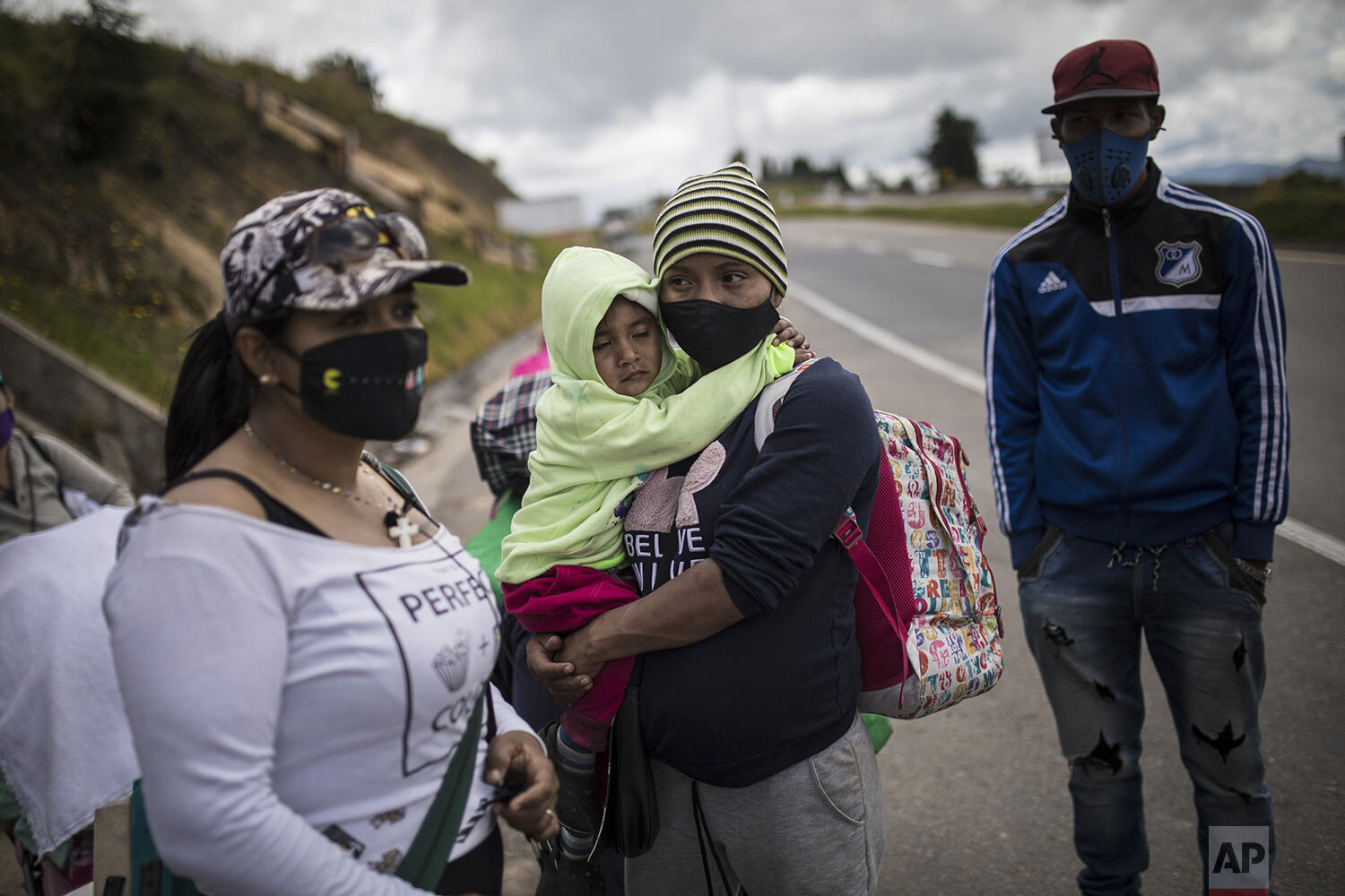  Venezuelan migrants rest as they walk towards Bogota, passing through Tunja, Colombia, Oct. 6, 2020. (AP Photo/Ivan Valencia) 