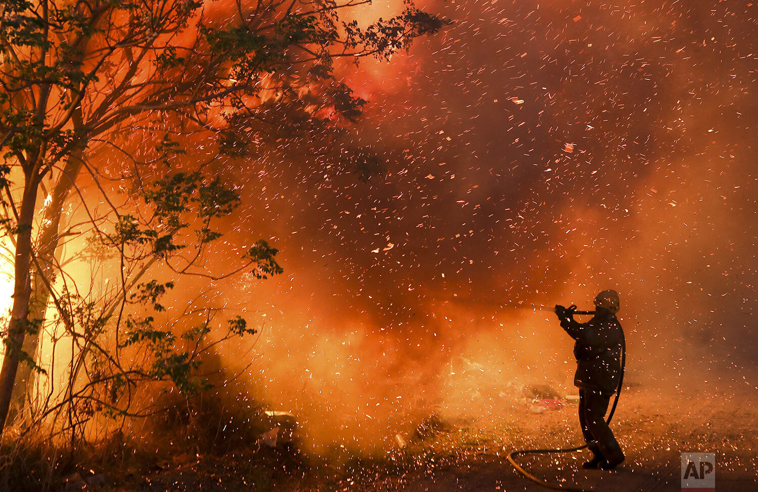  A firefighter battles flames in Cordoba, Argentina, Oct. 12, 2020. (AP Photo/Nicolas Aguilera) 