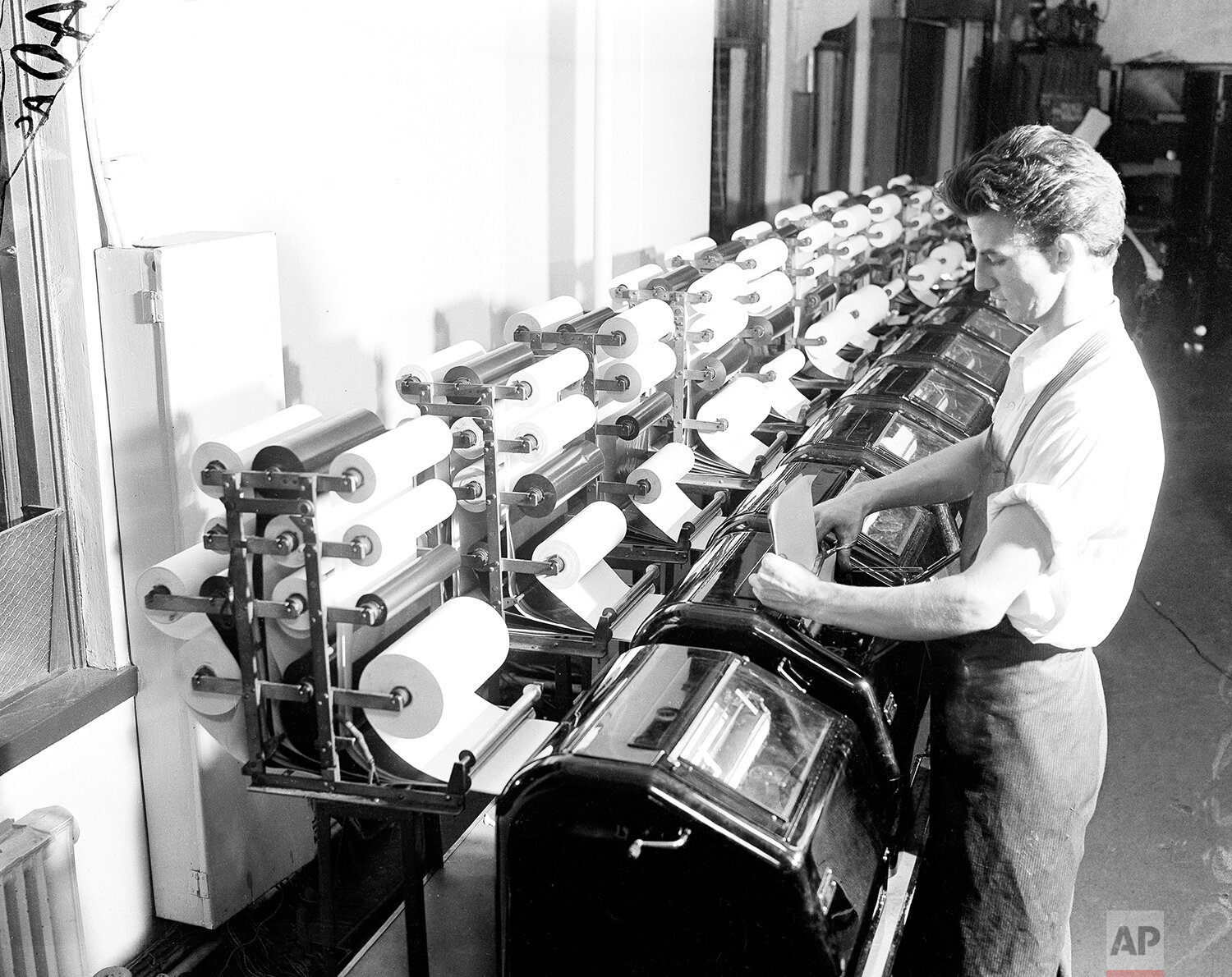  An Associated Press staffer reads copy from the election tabulator, November 1936. (AP Photo) 