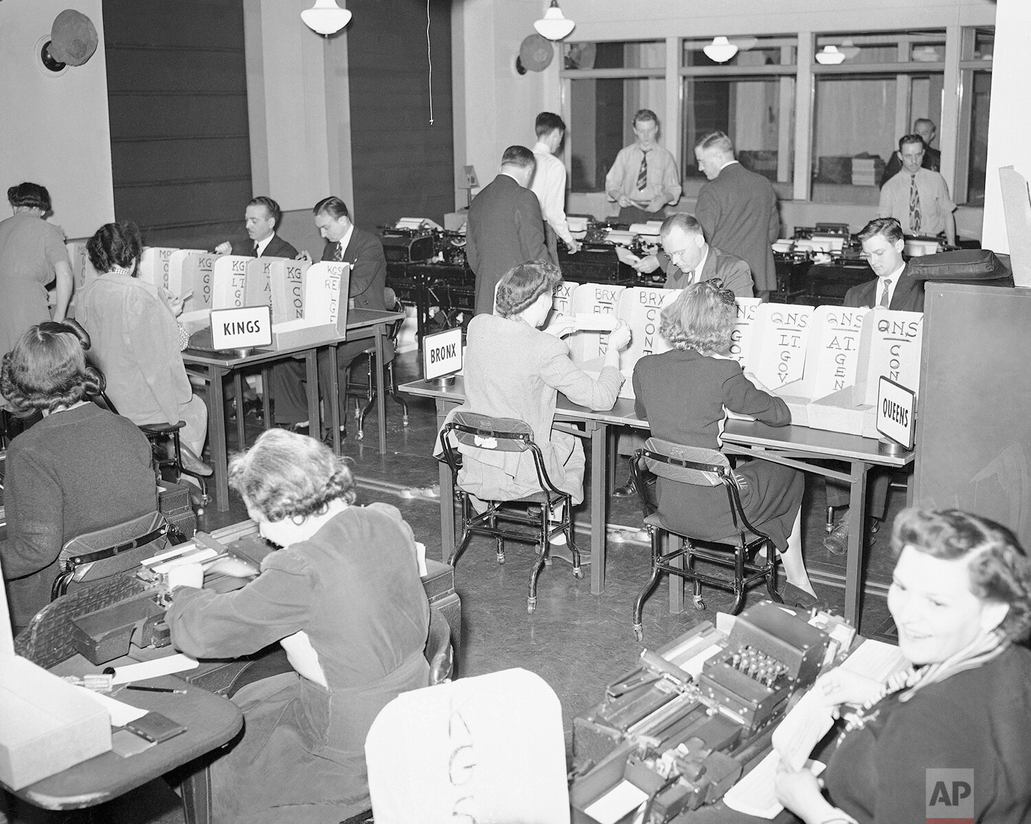  Tabulators record the Associated Press election returns in the offices of IBM in New York on Election Day, Nov. 3, 1942. The returns are received on the teletype machines, background, and recorded with the aid of the numeric punching and printing ma