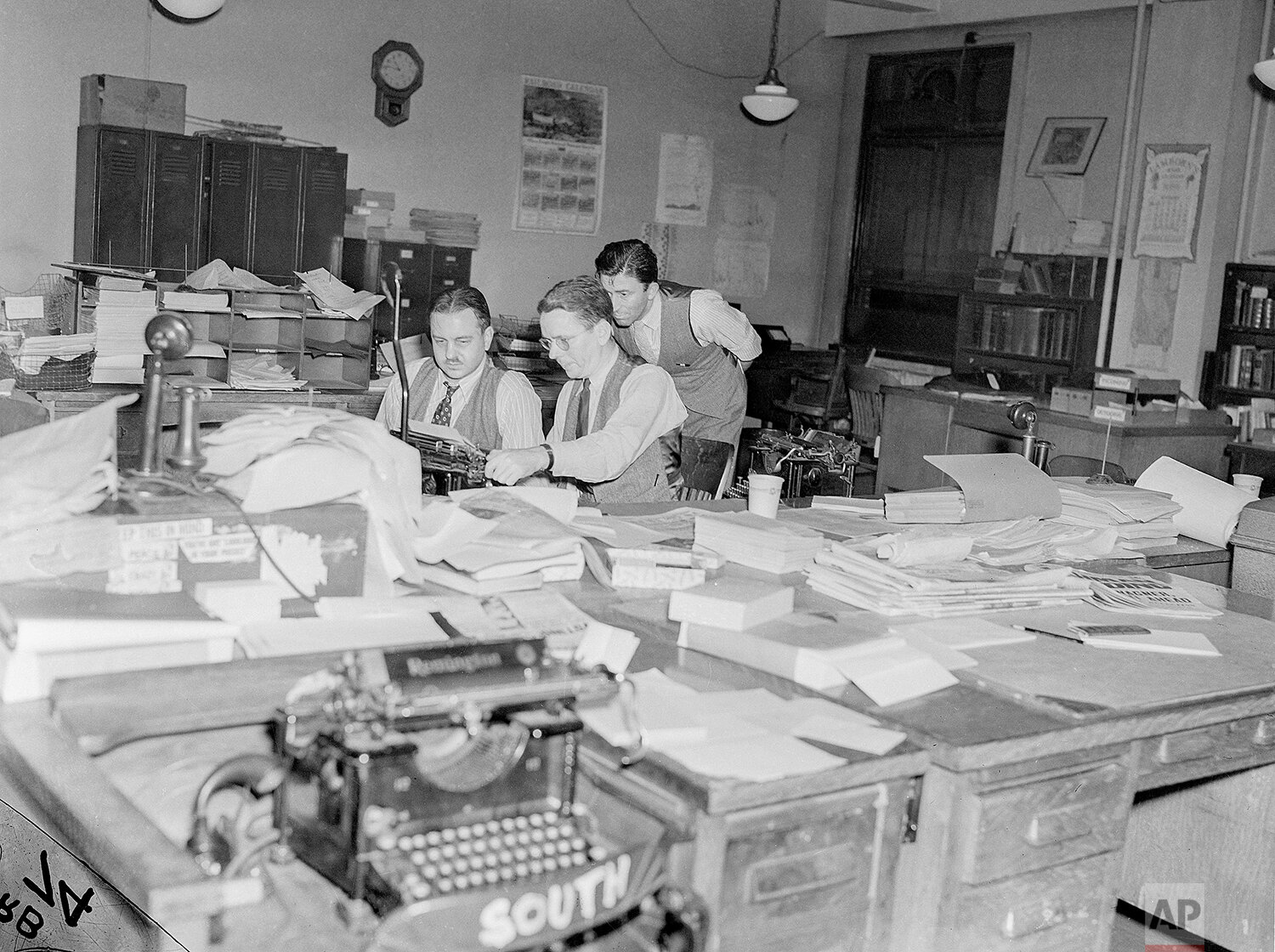  Associated Press editors are look over stories on election night, Nov. 8, 1938, in Washington. (AP Photo) 