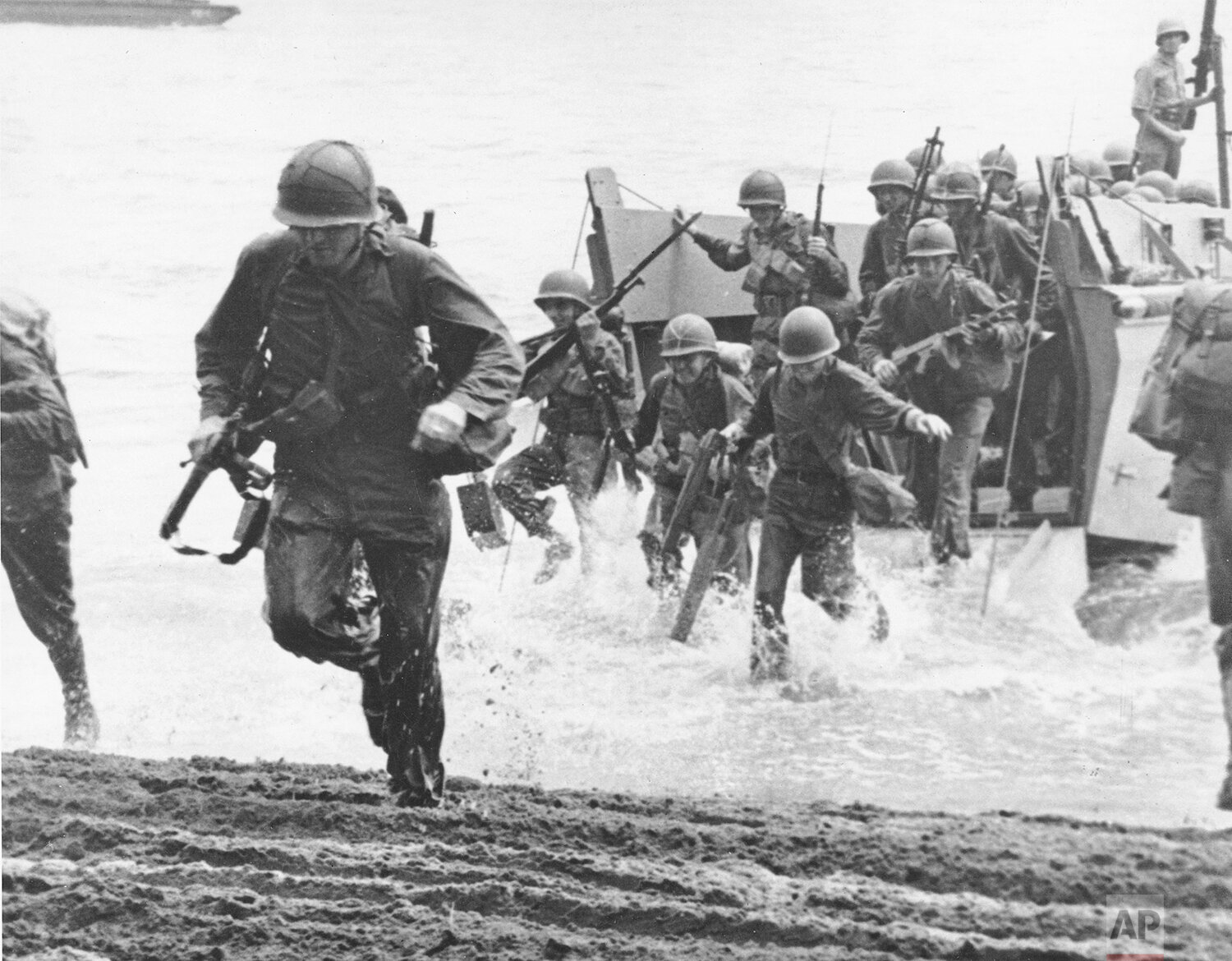  U.S. Marines, with full battle kits, charge ashore on Guadalcanal Island from a landing barge during the early phase of the U.S. offensive in the Solomon Islands in August 1942 during World War II. (AP Photo) 