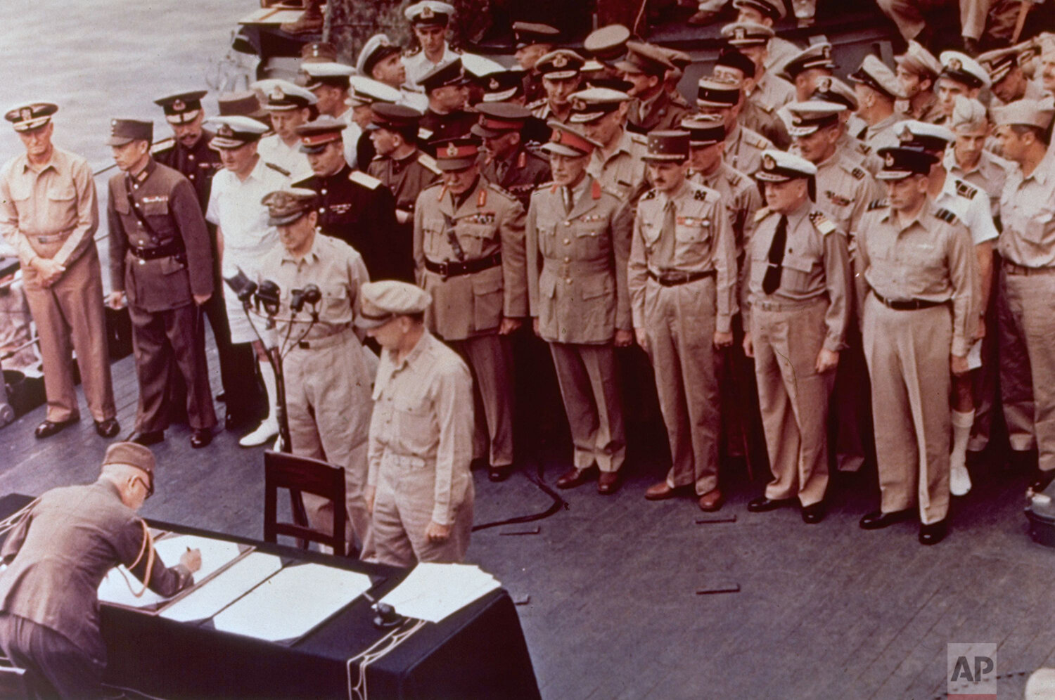  General of the Army Douglas MacArthur, Supreme Allied Commander, and General Wainwright, who surrendered to the Japanese after Bataan and Corregidor, are shown witnessing the formal Japanese surrender signatures aboard the U.S.S. Missouri in Tokyo B