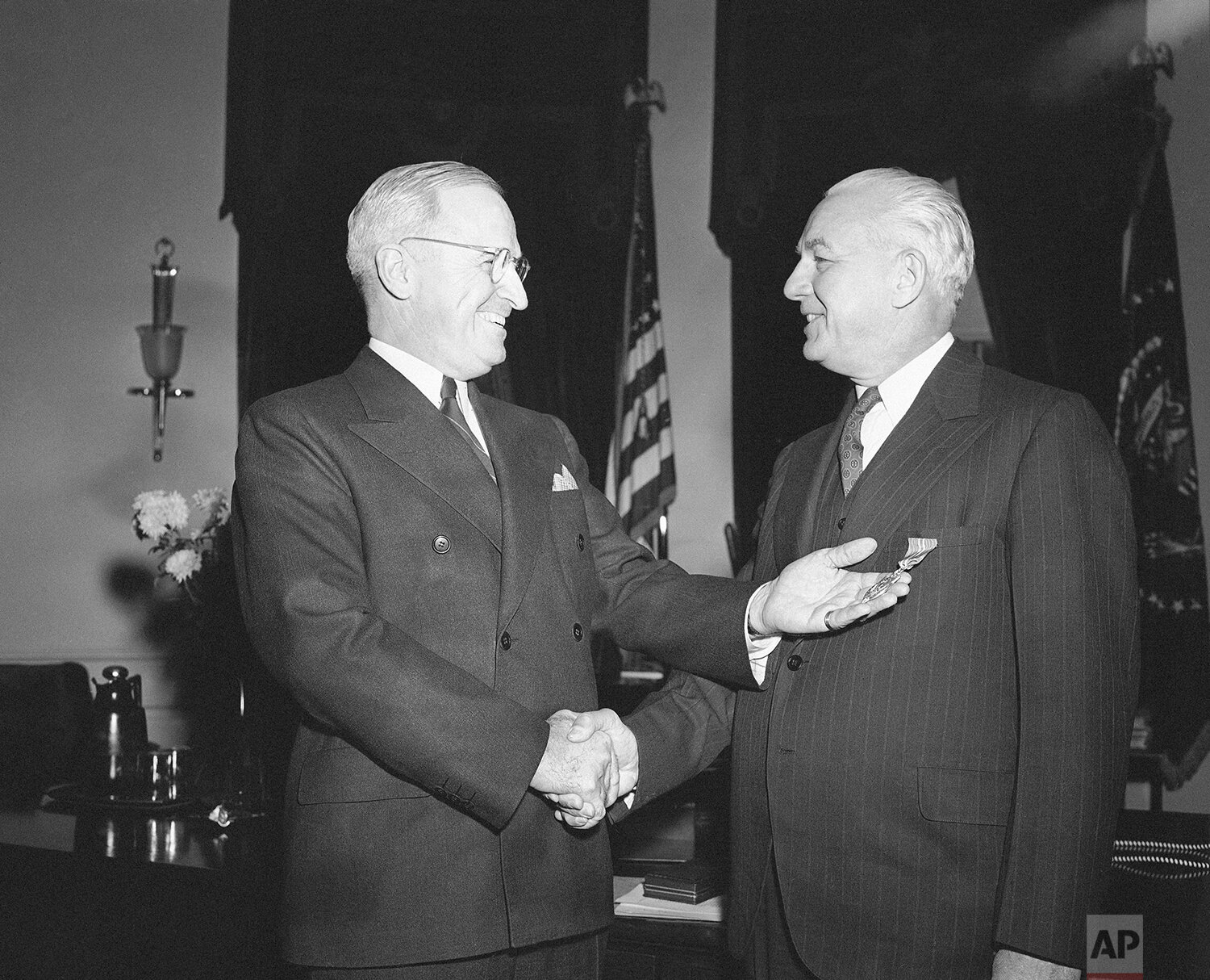  Byron Price, right, wartime chief of censorship, is congratulated by President Harry Truman at the White House in Washington on Jan. 15, 1946 after receiving the Medal of Merit for his services during the war. (AP Photo) 