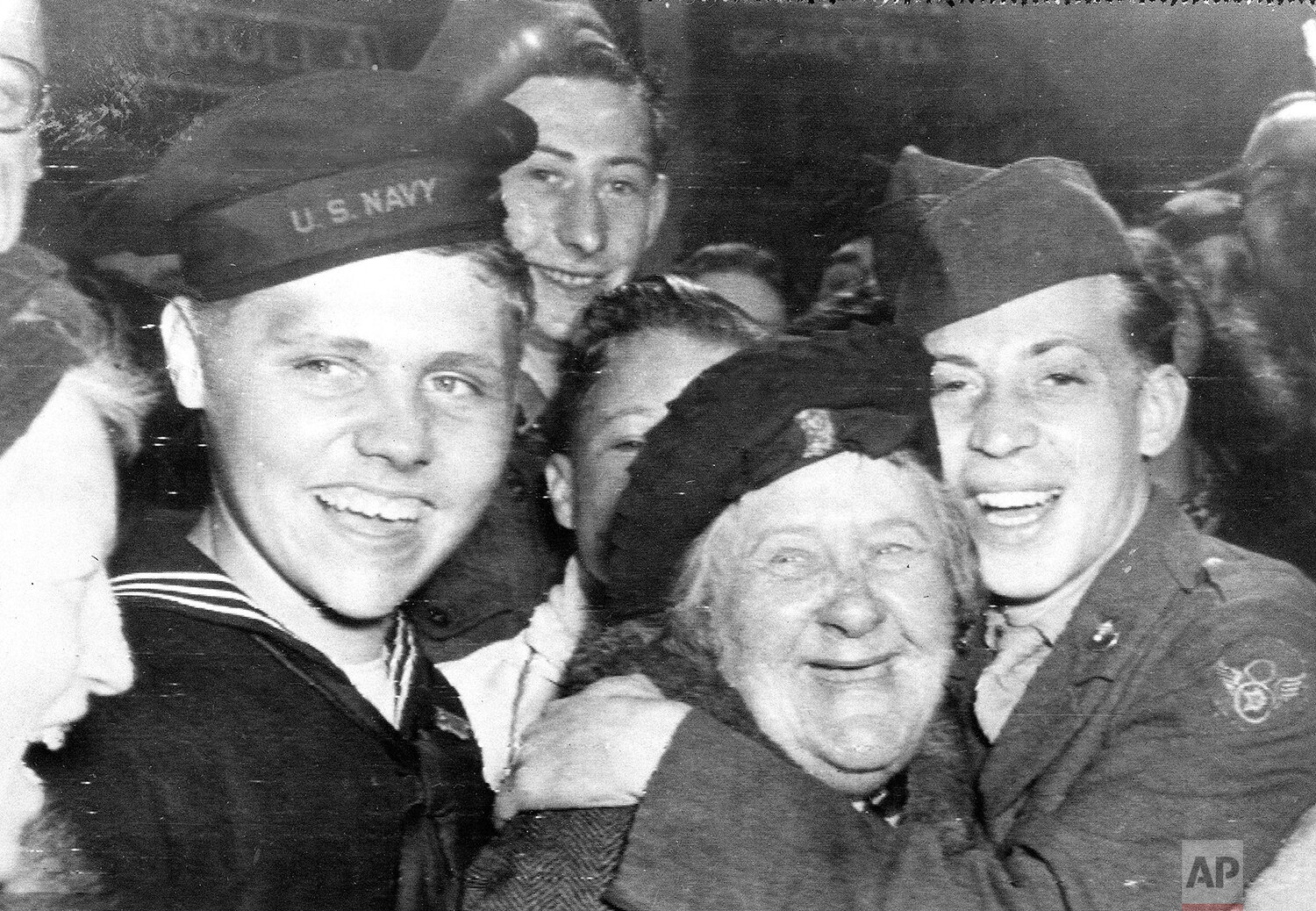  An American soldier, right, hugs an Englishwoman as other U.S. soldiers celebrate the surrender of Germany, May 7, 1945, in London's Piccadilly Circus. (AP Photo) 