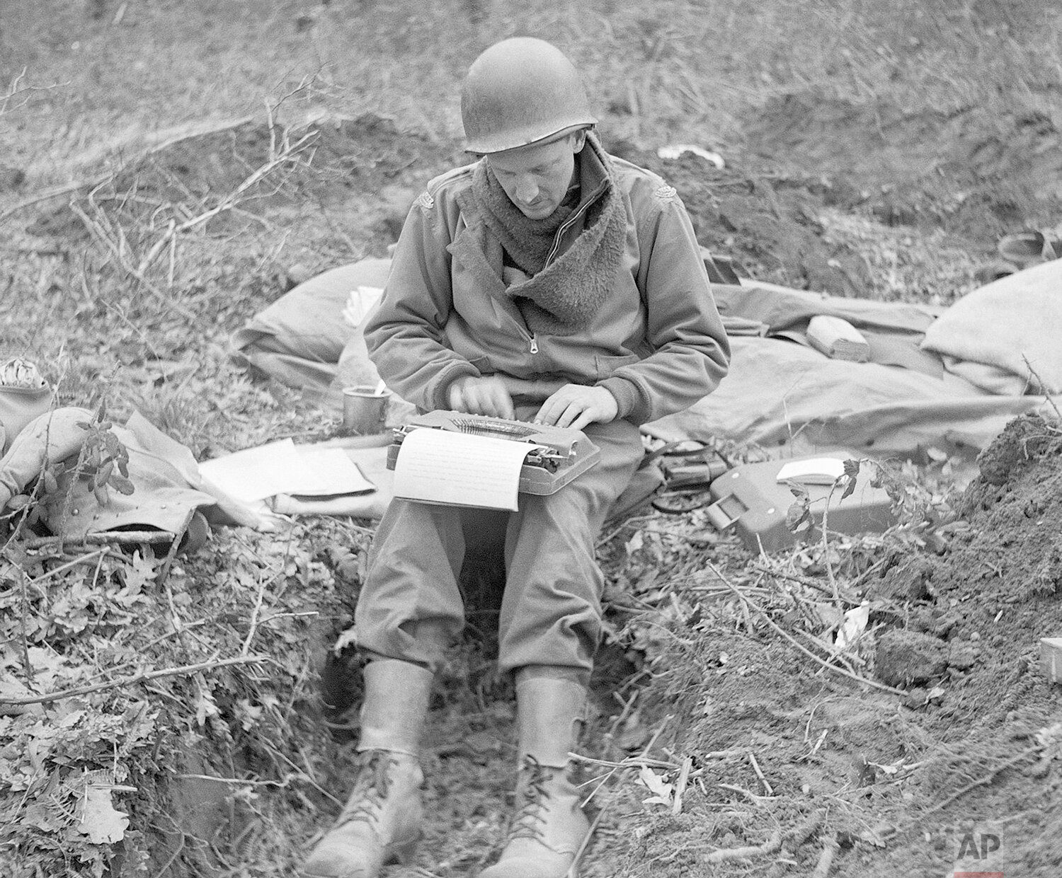  In this February 1944, photo, Don Whitehead, Associated Press correspondent, writes his story of the landing at Anzio Beach in Italy, from a fox hole. Whitehead, known by his colleagues as “Beachhead Don,” returned to Normandy for the tenth annivers