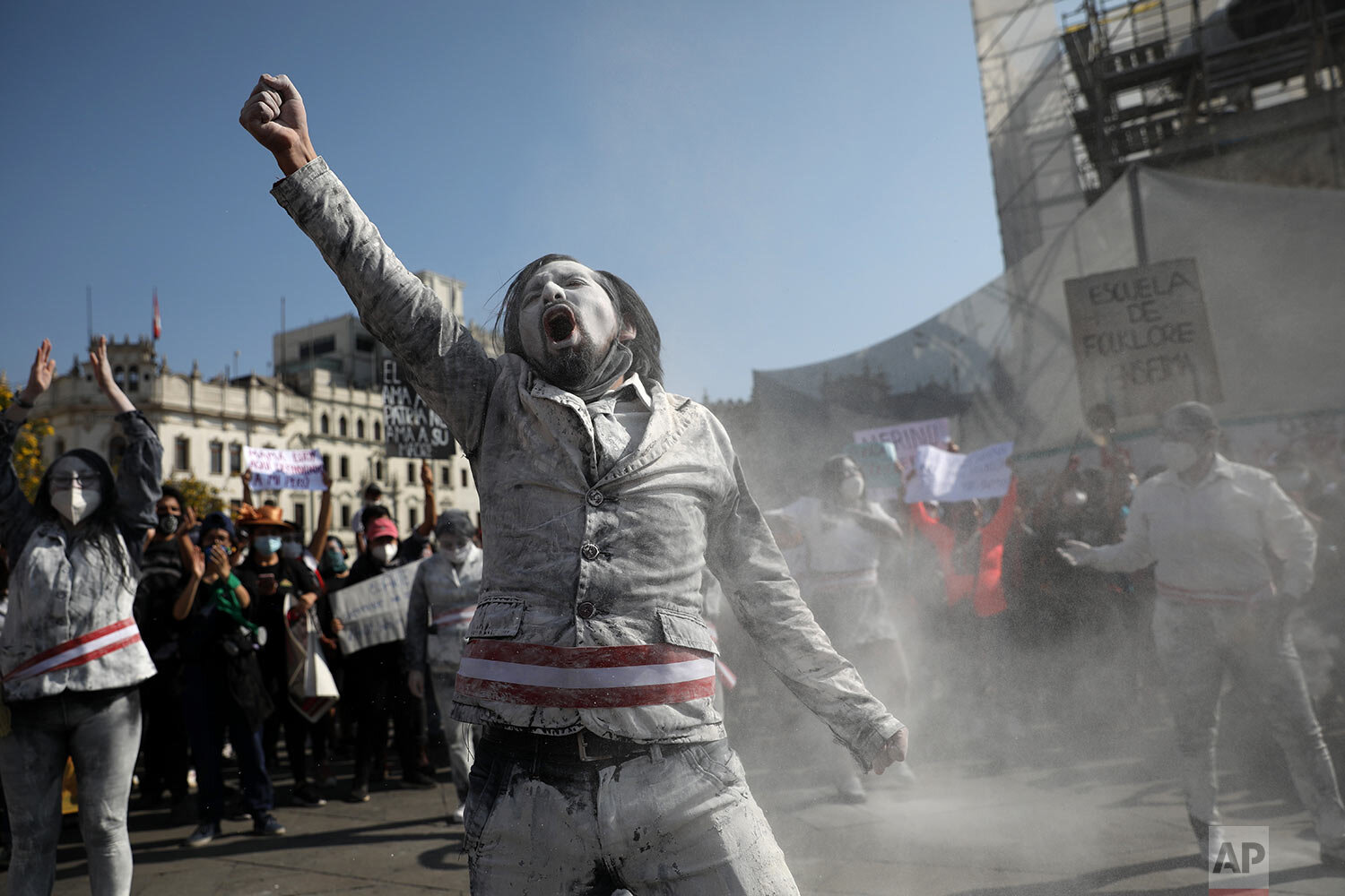  A man who is dressed as a zombie wears a presidential sash to represent himself as a minister of Peru's newly sworn-in president, gets revved up in San Martin plaza where people who are refusing to recognize the new government gather to protest, in 