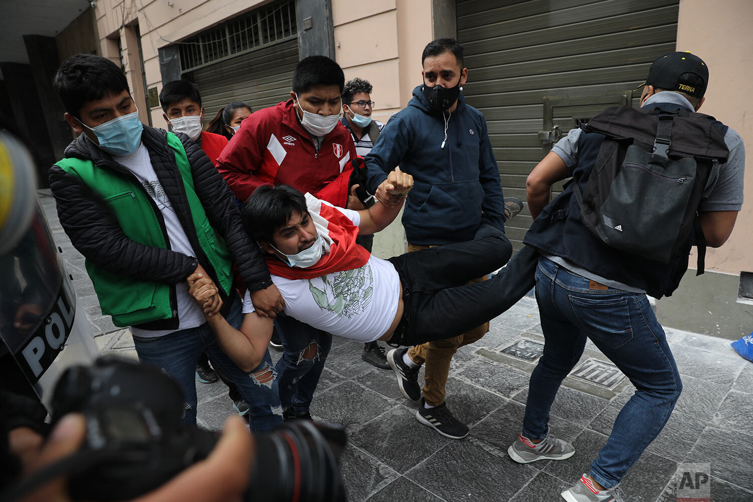  Police in civilian clothes detain a supporter of former President Martin Vizcarra as he and other protesters are blocked from reaching Congress to protest against the swearing-in of Manuel Merino, head of Peru's legislature, as the new president in 