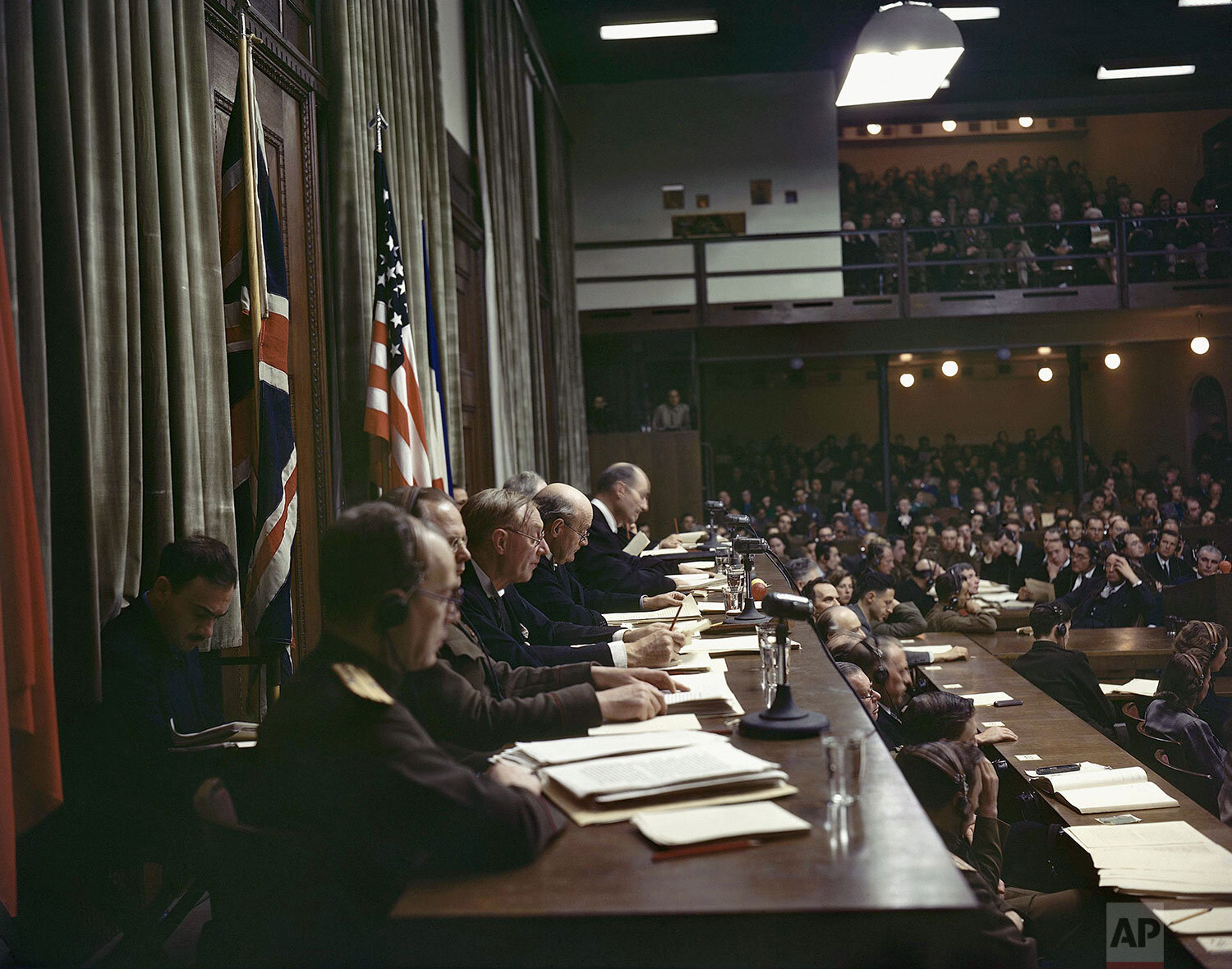  Members of the International Military Tribunal read the verdicts in the courtroom of the Palace of Justice in Nuremberg, Germany, on Sep. 30, 1946. (AP Photo/Eddie Worth) 