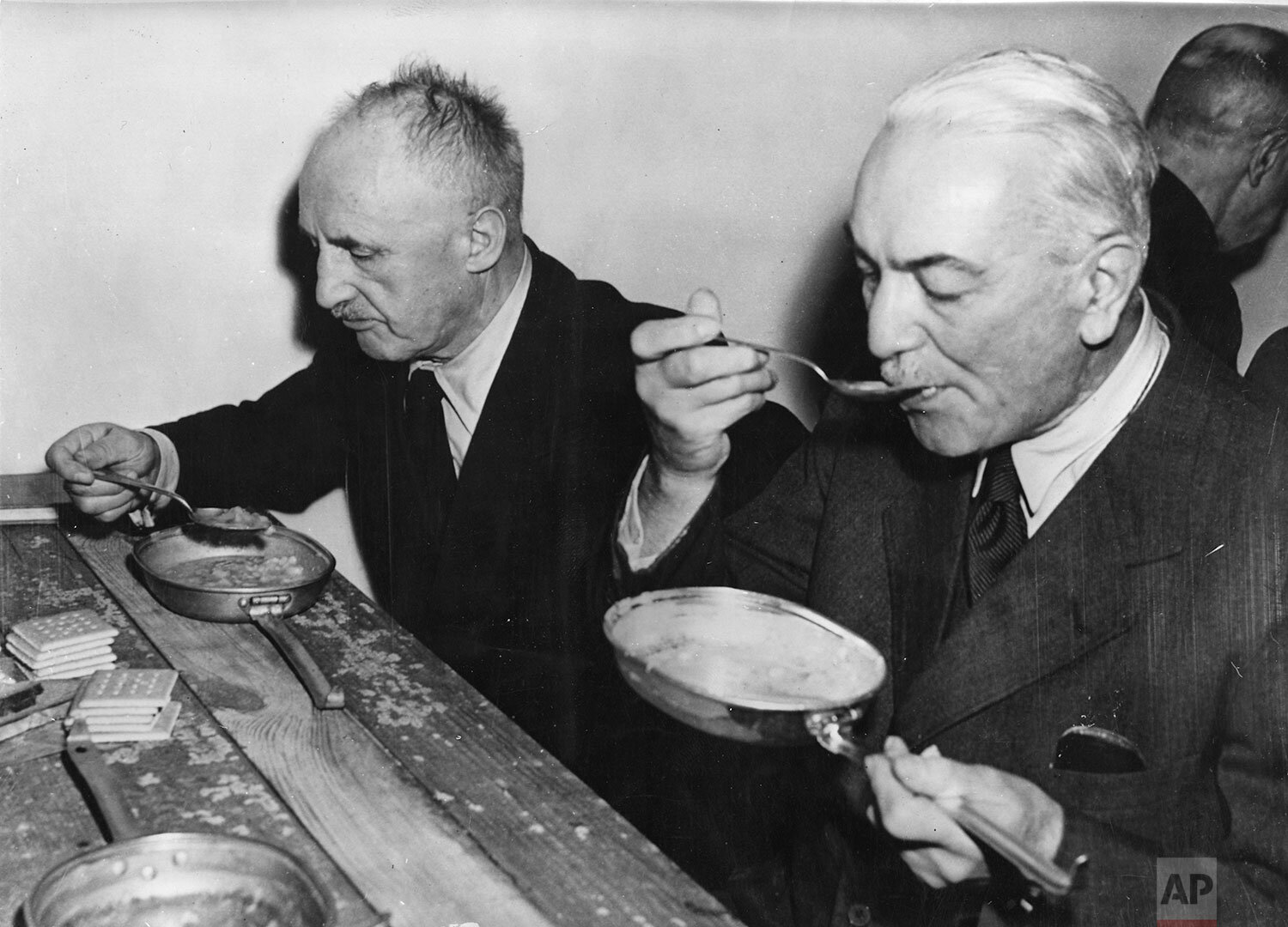  Former Foreign Minister of the German Reich, Dr. Konstantin von Neurath, right, and Julius Streicher eating their lunches from U.S. American Army mess tins on a bare board table, in the Palace of Justice, in Nuremberg, Germany, November 29, 1945. Bo
