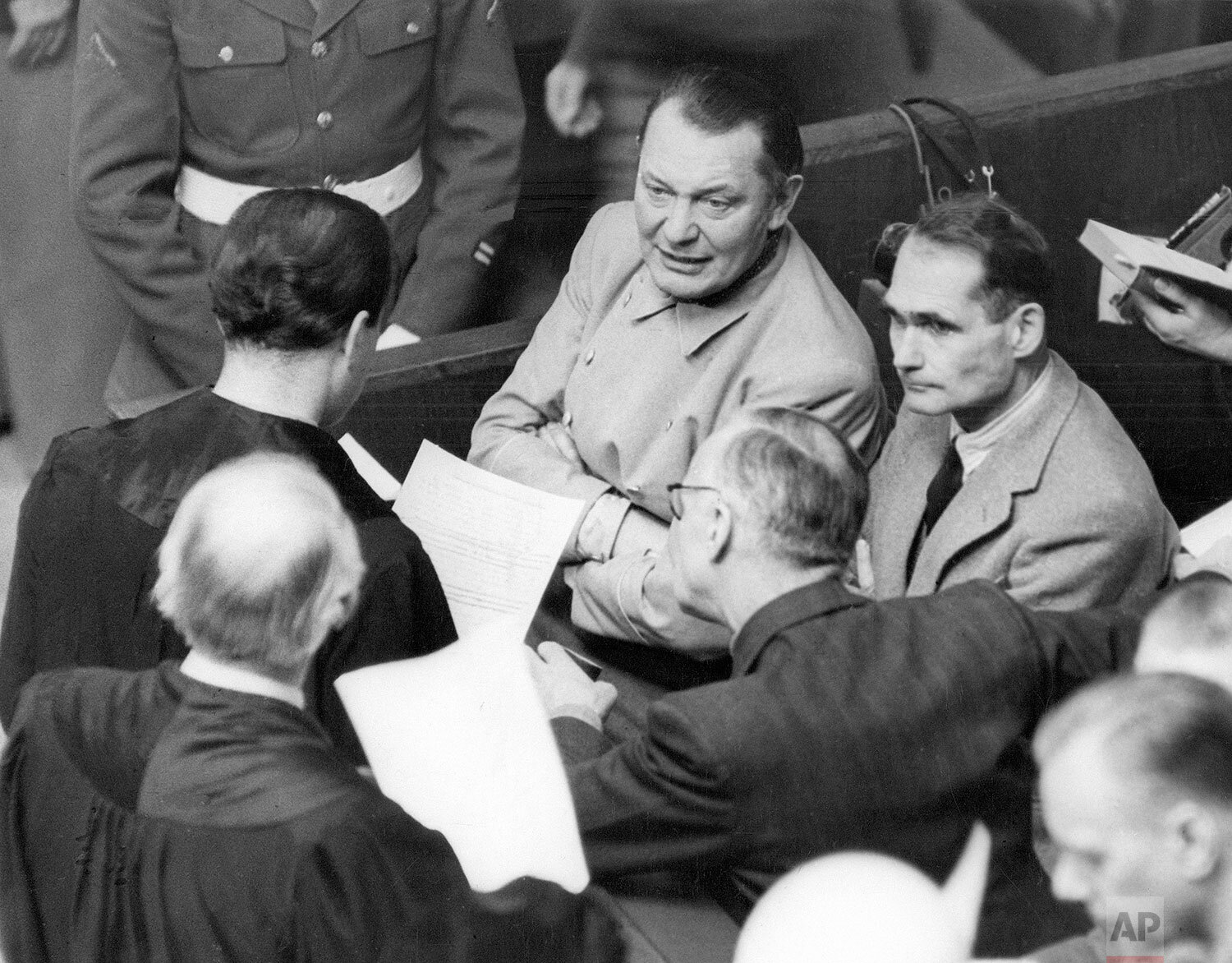  Rudolf Hess, right, has asked permission of the international military tribunal to be allowed to act as his own attorney “from now until the end of the trial.” He is discussing his application during a recess in the Nuremberg trial, with Goering, Ri