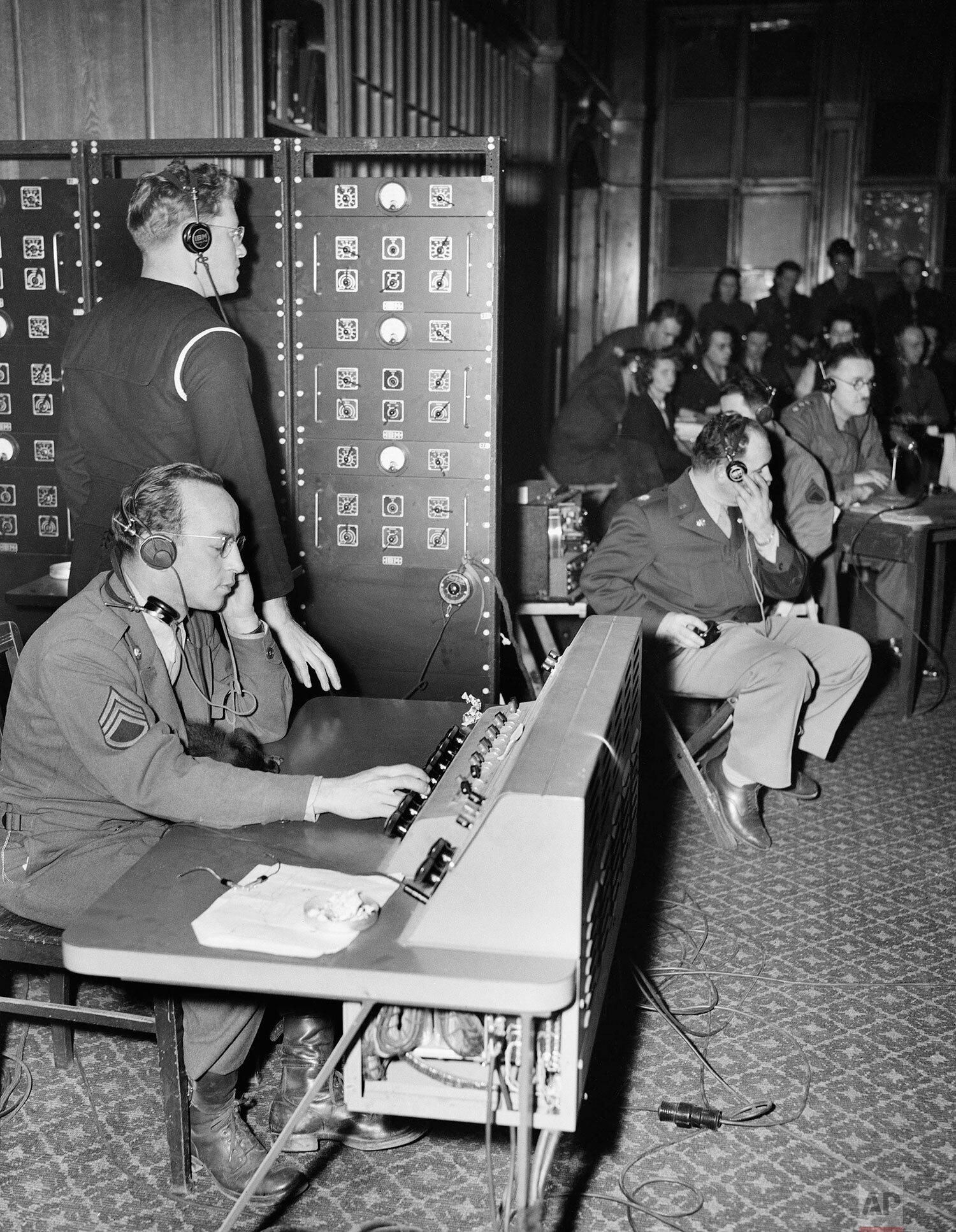  Interpreters and audio technicians work behind the scenes at the Nuremburg trials, in Nuremburg, Germany, Nov. 18, 1945.  (AP Photo/B.I. Sanders) 