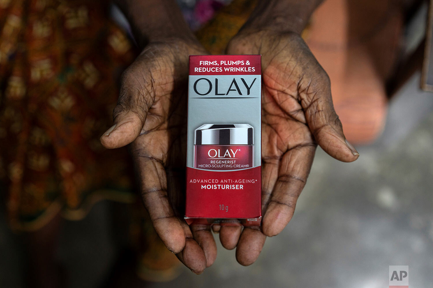  A 102-year-old woman holds a skincare product outside her house in Malaysia, on Wednesday, Nov. 11, 2020. Her parents were migrant workers and brought her to the country from India when she was a baby so the family could work on a rubber plantation,