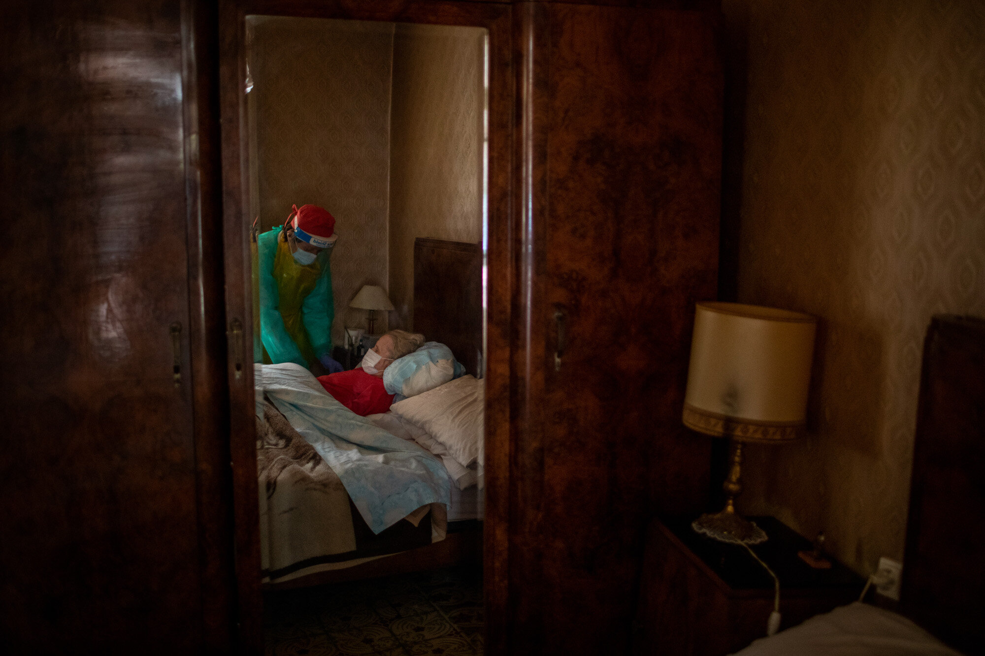  Josefa Ribas, 86, who is bedridden and suffers from dementia, is attended to by nurse Laura Valdes during a home care visit in Barcelona, Spain, on April 7, 2020. Ribas' husband, Jose Marcos, fears what will happen if the coronavirus enters their ho