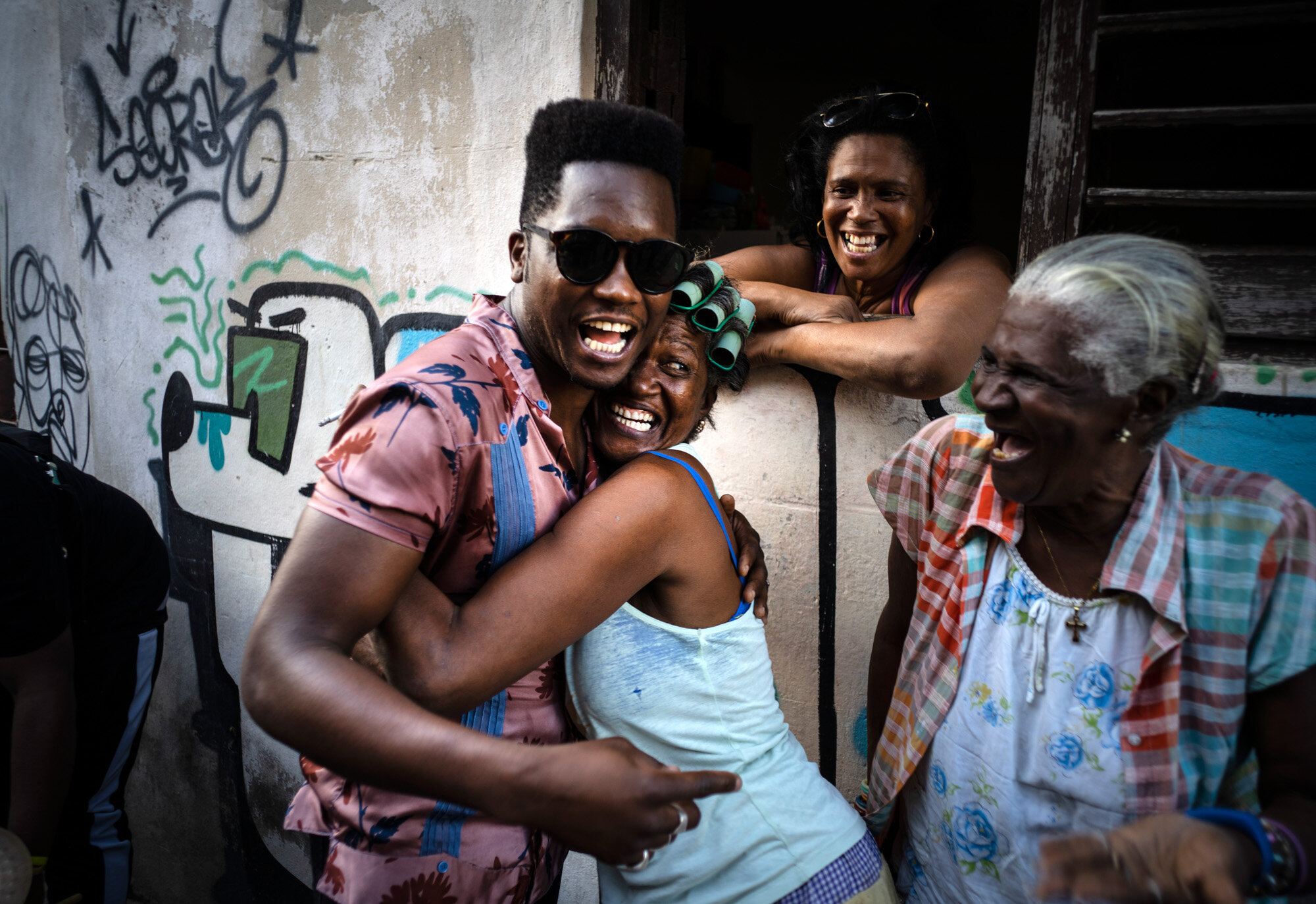 Cuban singer Cimafunk hugs a woman during a music conga through the streets of Cuba’s Old Havana neighborhood during the 35th Havana International Jazz Festival on Jan. 15, 2020. (AP Photo/Ramon Espinosa)