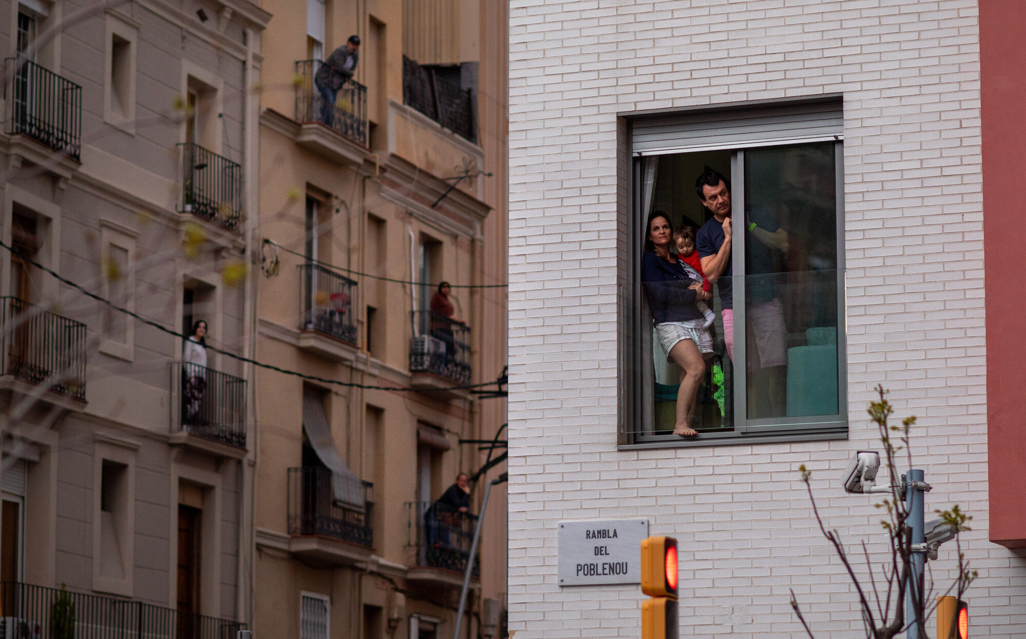  People stand in their balconies during a nationwide confinement to counter the coronavirus in Barcelona, Spain on March 29, 2020. (AP Photo/Emilio Morenatti) 