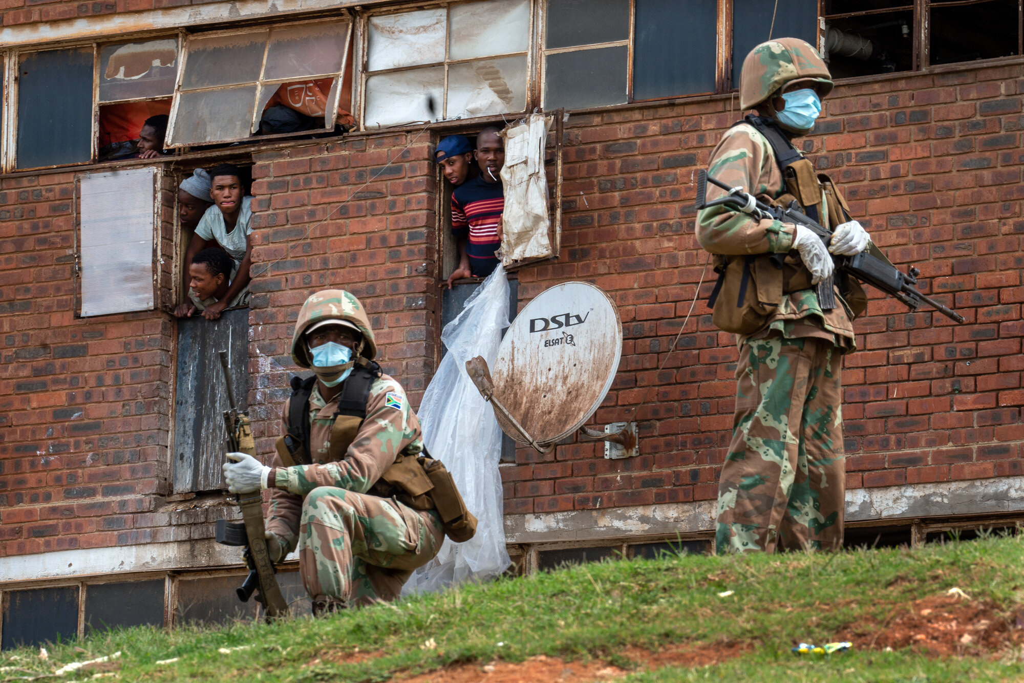 South African National Defense Forces patrol the Men's Hostel in the densely populated Alexandra township east of Johannesburg on March 28, 2020, enforcing a strict lockdown in an effort to control the spread of the coronavirus. (AP Photo/Jerome Del