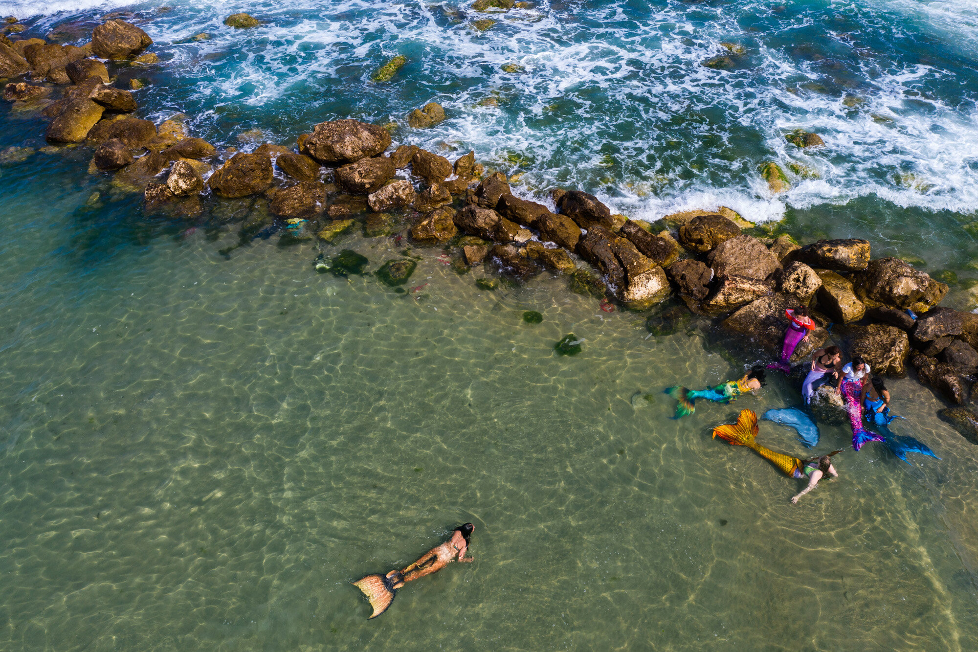  Members of the Israeli Mermaid Community swim with mermaid tails at the beachfront in Bat Yam, near Tel Aviv, Israel, on May 23, 2020. (AP Photo/Oded Balilty) 