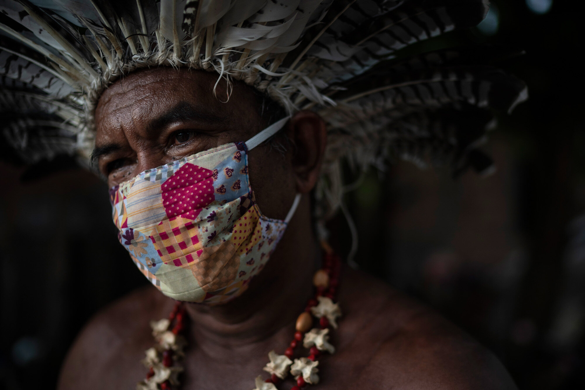 Cacique Pedro poses for a photo as he sits outside his house in the “Park of Indigenous Nations” community in Manaus, Brazil, on May 10, 2020. (AP Photo/Felipe Dana)