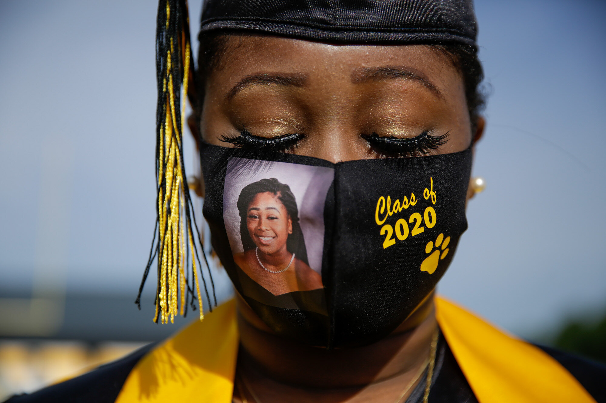 Yasmine Protho, 18, wears a photo of herself and “Class of 2020” on her protective mask amid the COVID-19 virus outbreak as she graduates with only nine other classmates and limited family attending at Chattahoochee County High School in Cusseta, Ga., on May 15, 2020. (AP Photo/Brynn Anderson)