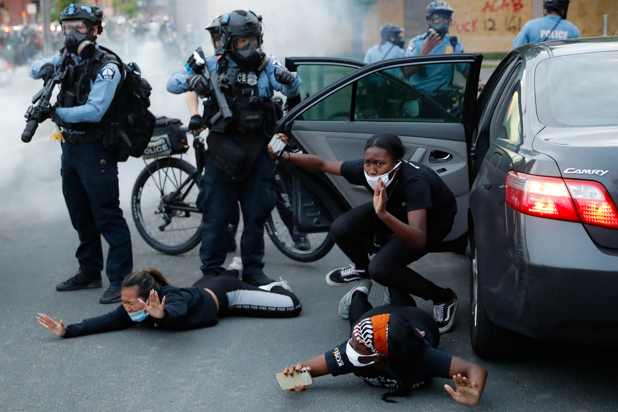  Motorists are ordered to the ground from their vehicle by police on May 31, 2020, during a protest in Minneapolis over the death of George Floyd, a Black man who died after a white Minneapolis police officer pressed a knee into his neck for several 