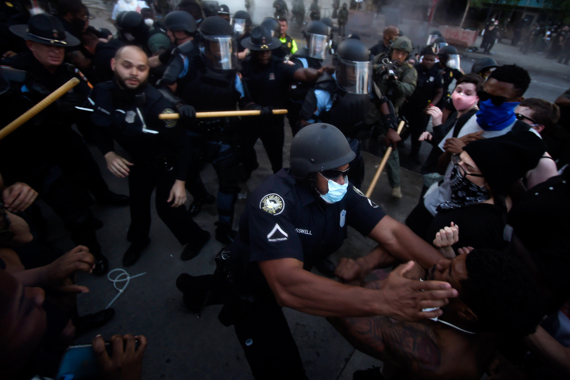 Police officers and protesters clash in Atlanta on May 29, 2020, during a protest in response to George Floyd's death in police custody in Minneapolis. Floyd, a Black man, died after a white police officer pressed a knee into his neck for several minutes even after he stopped moving and pleading for air. (AP Photo/Mike Stewart)